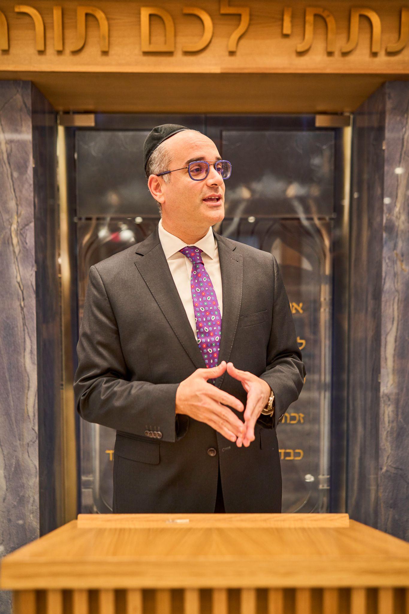 Man speaking beside an open ark holding the Torah scrolls — Religious Ceremonies photography, Austin A man speaking beside an open ark holding the Torah scrolls.
