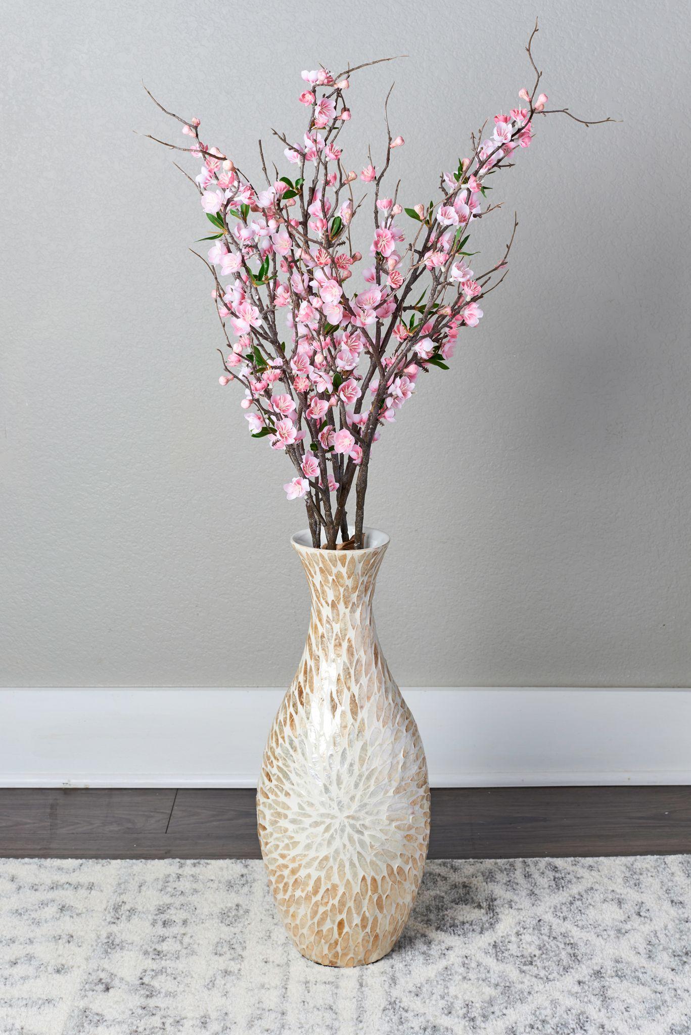 Tall speckled ceramic vase of pink cherry blossom branches against a pale gray wall — E-commerce & apparel photography, Austin Tall speckled ceramic vase of pink cherry blossom branches against a pale gray wall