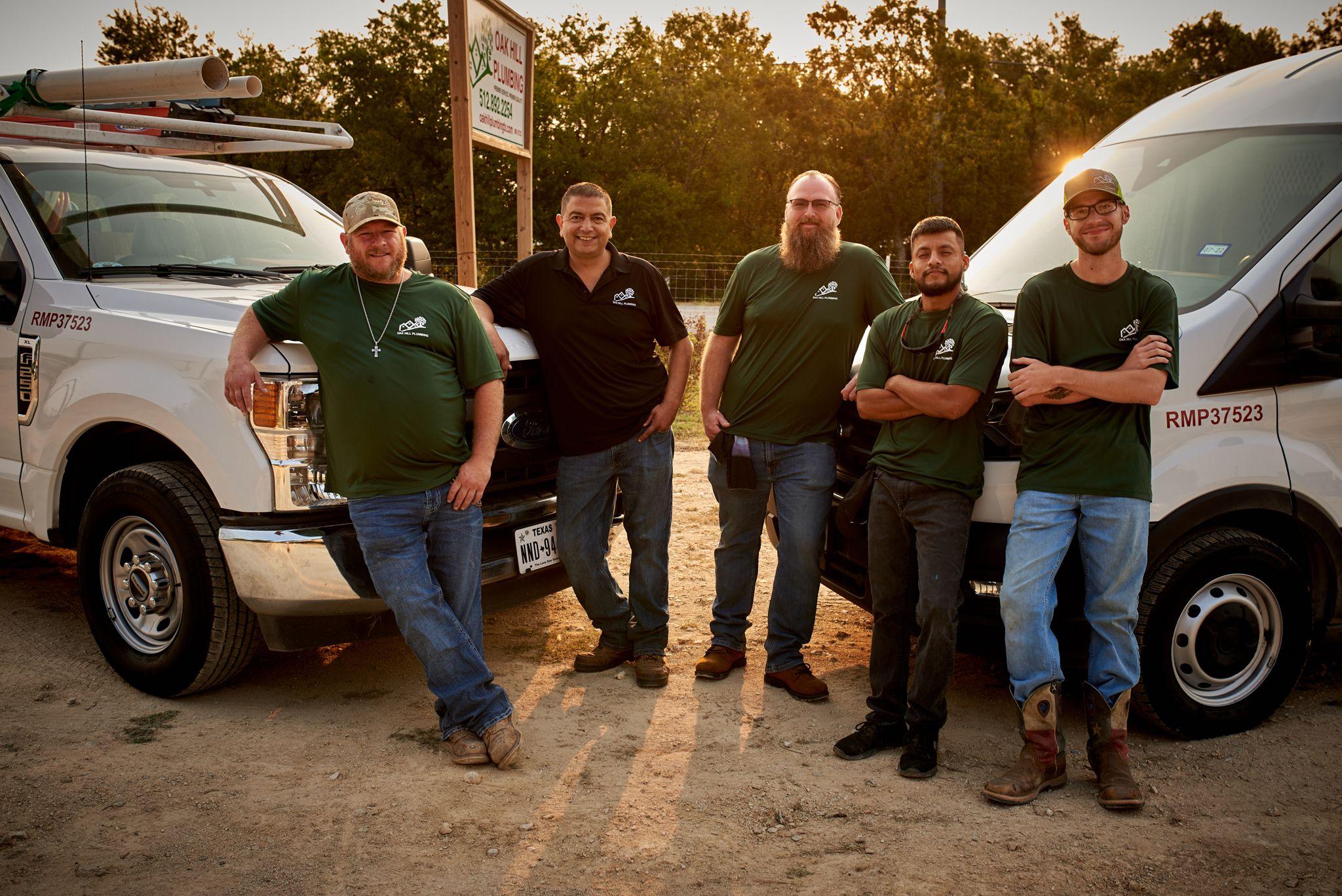 Work crew in caps and branded shirts standing by a truck in low evening sun — Team photography, Austin Work crew in caps and branded shirts standing by a truck in low evening sun