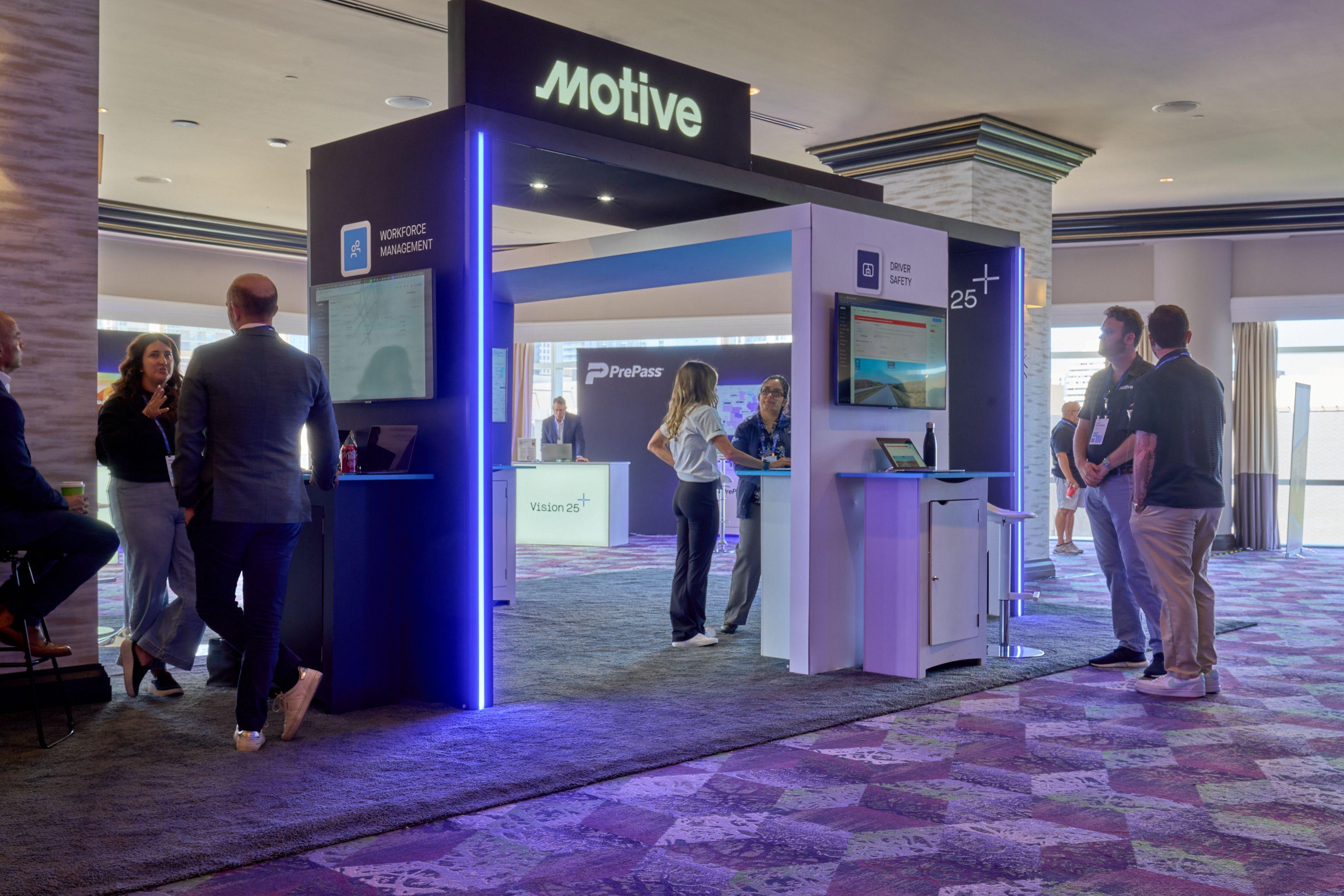 Visitor browsing screens inside the Motive tradeshow booth — Conventions & Tradeshows photography, Austin A visitor browsing screens inside the Motive tradeshow booth.