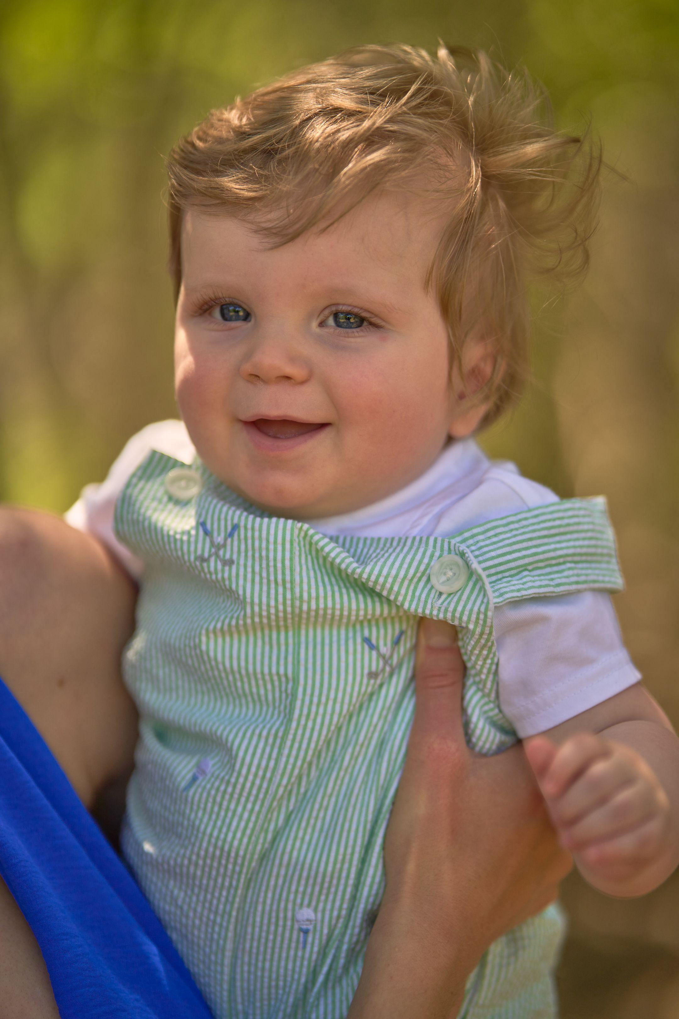 Close frame of a baby in a striped shirt held up in the light at Circle C Ranch — Circle C Ranch photography, Austin A close frame of a baby in a striped shirt held up in the light at Circle C Ranch