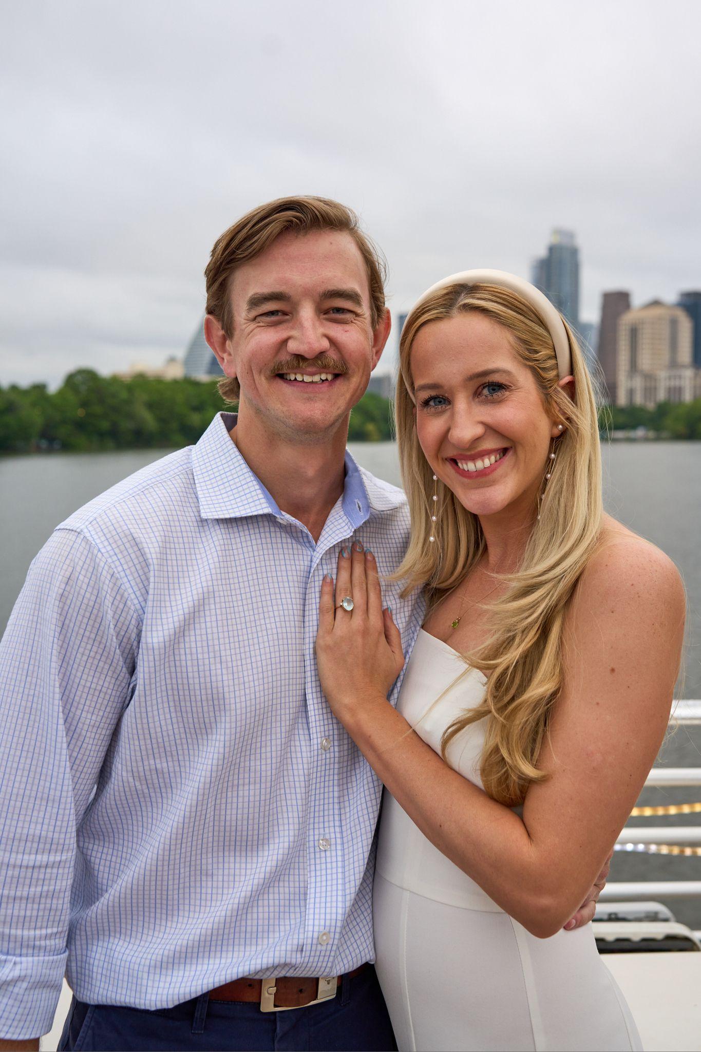 Couple posed together by the lake, the downtown Austin skyline behind them — Couples & Anniversary photography, Austin A couple posed together by the lake, the downtown Austin skyline behind them.