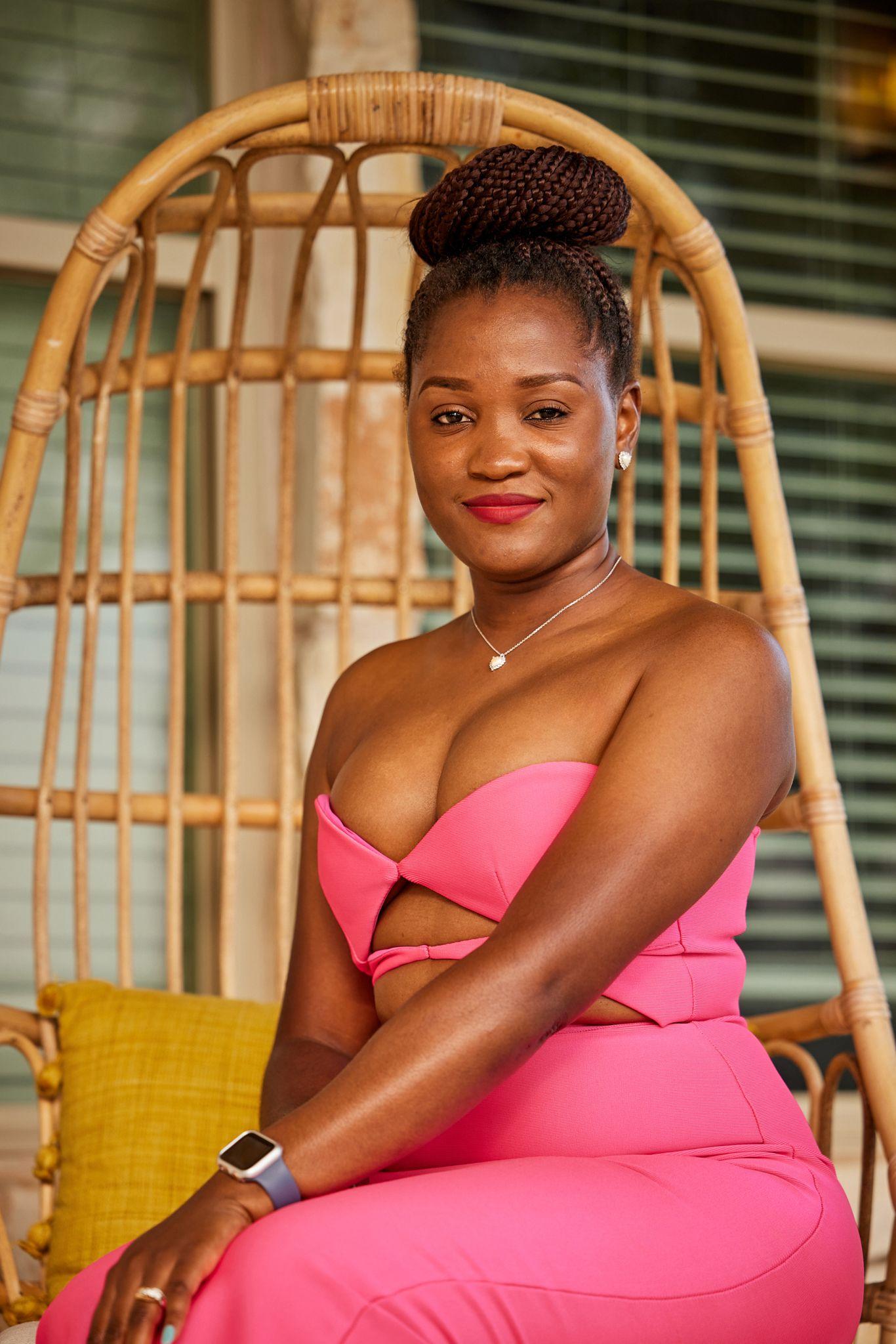 Woman in a pink dress seated in a hanging rattan chair — Portrait photography, Austin A woman in a pink dress seated in a hanging rattan chair.