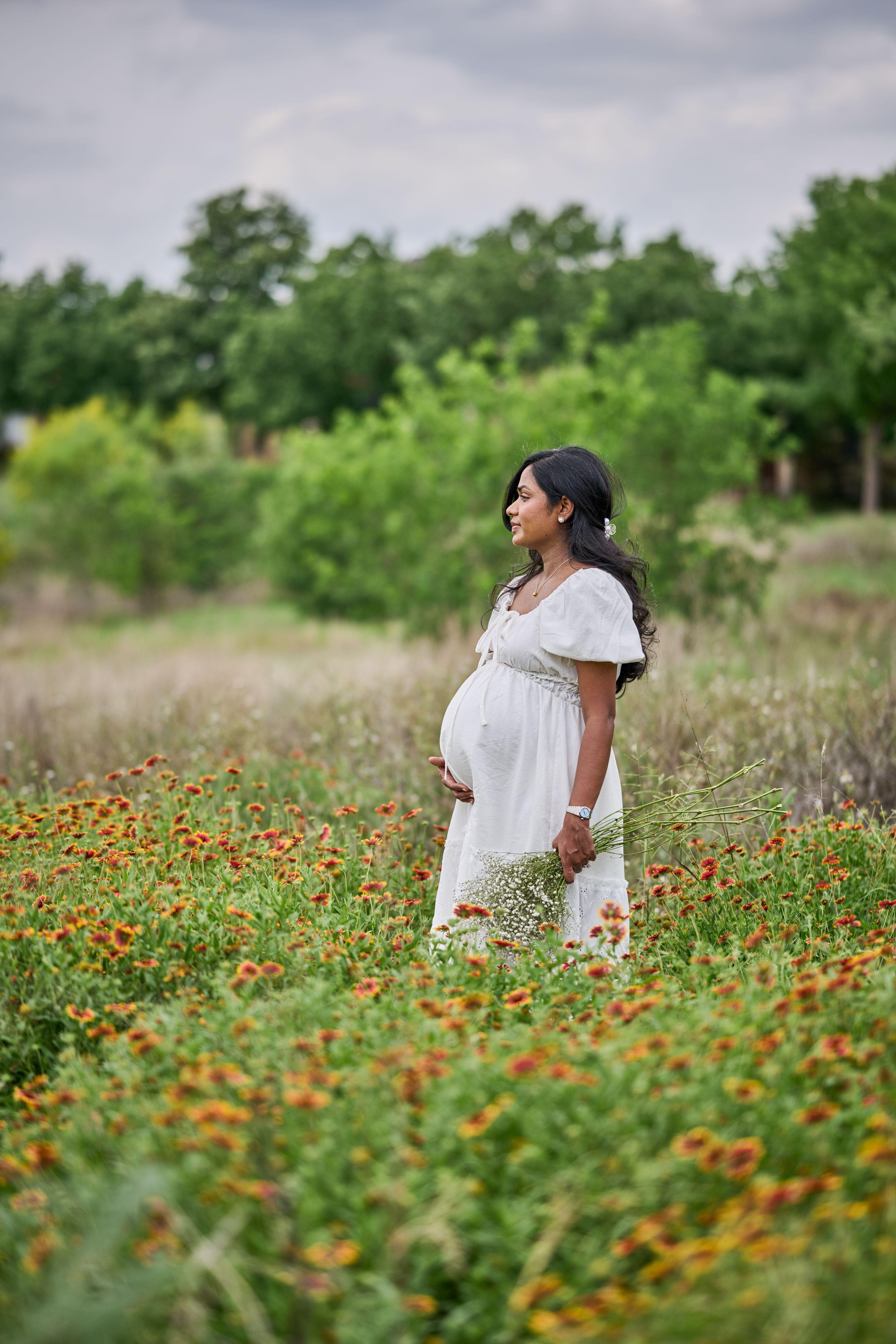 Expectant mother in a white dress in a wildflower field — Maternity photography, Austin Expectant mother in a white dress in a wildflower field