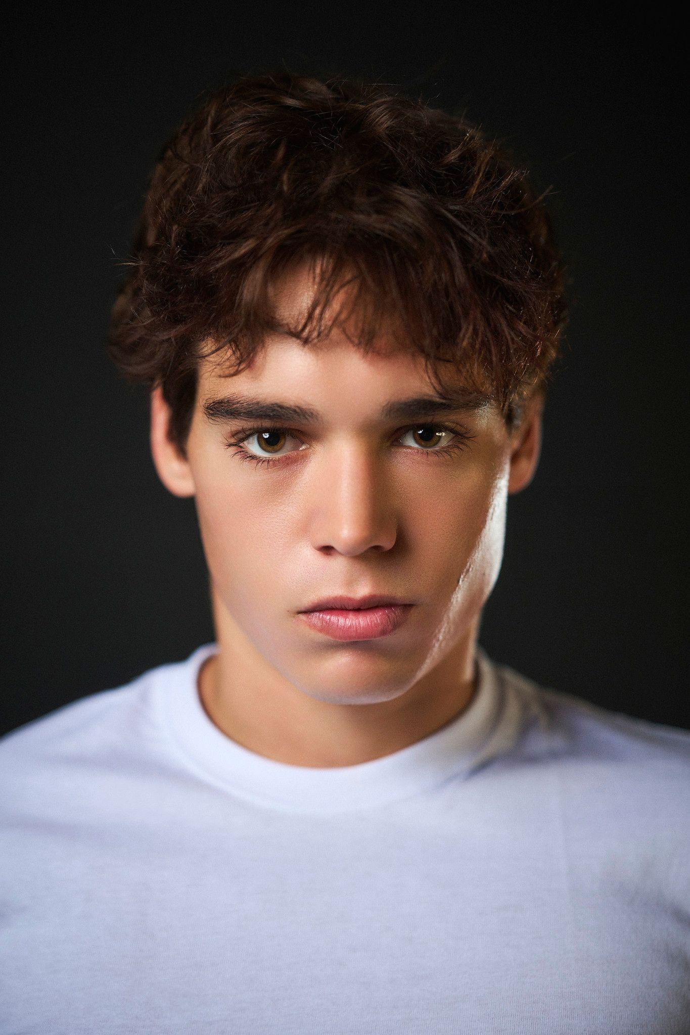 Male model with curly hair in a white t-shirt against a dark background — Photo retouching, Austin A male model with curly hair in a white t-shirt against a dark background.