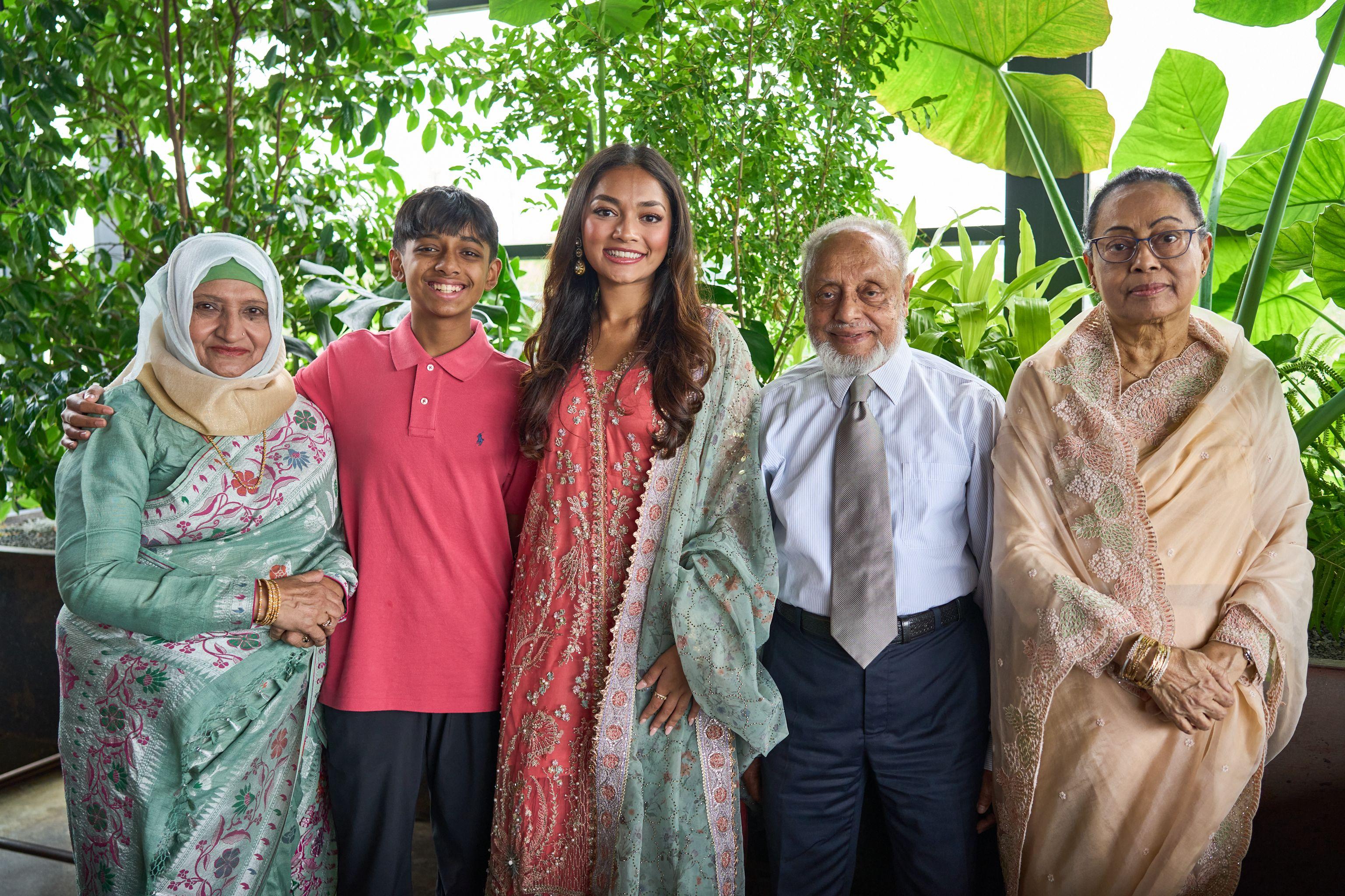 Three generations posed together in a garden, the grandfather in a shirt and tie — Family Portraits photography, Austin Three generations posed together in a garden, the grandfather in a shirt and tie.