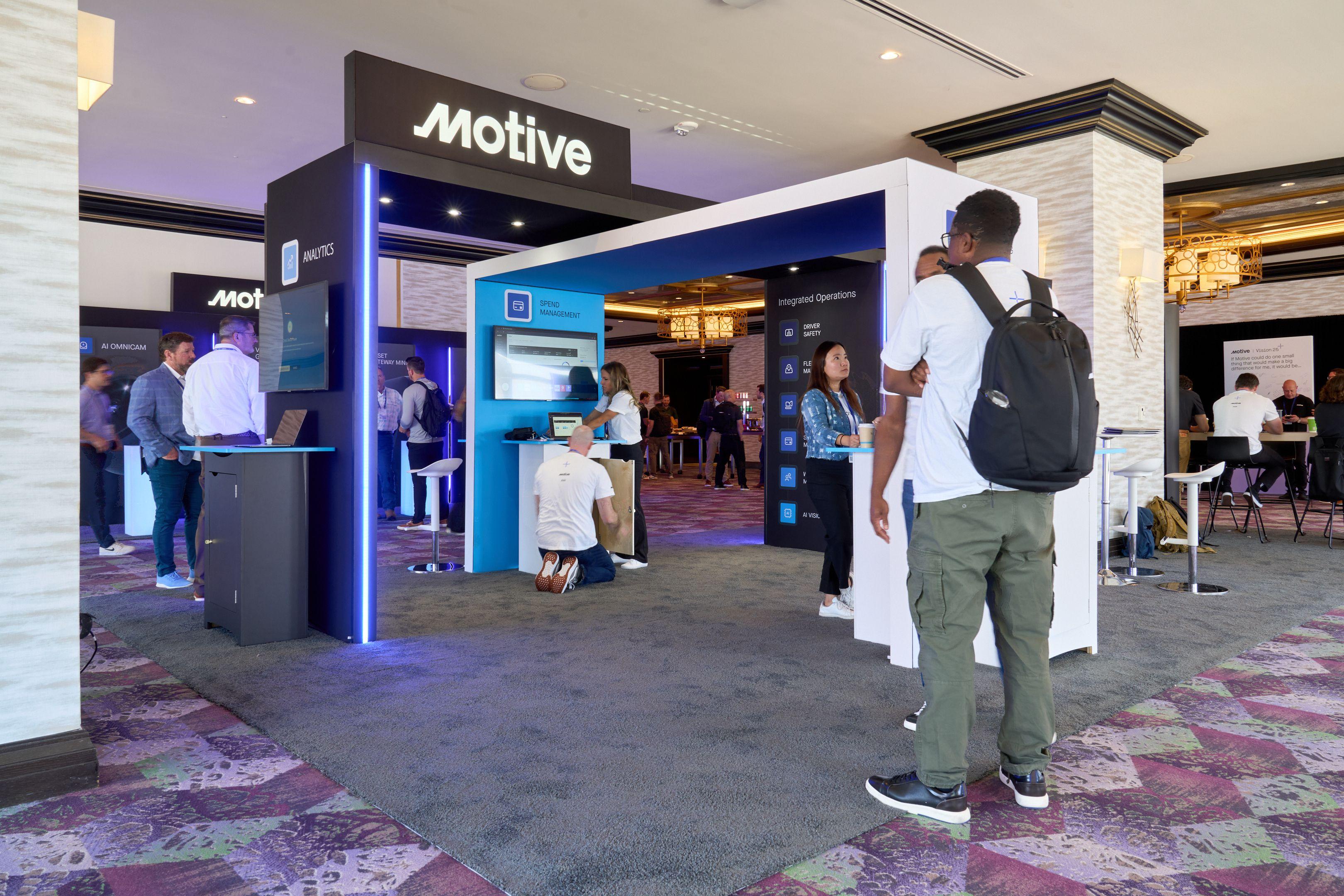 Delegates with lanyards moving through the entrance of the Motive exhibition stand — Conventions & Tradeshows photography, Austin Delegates with lanyards moving through the entrance of the Motive exhibition stand.