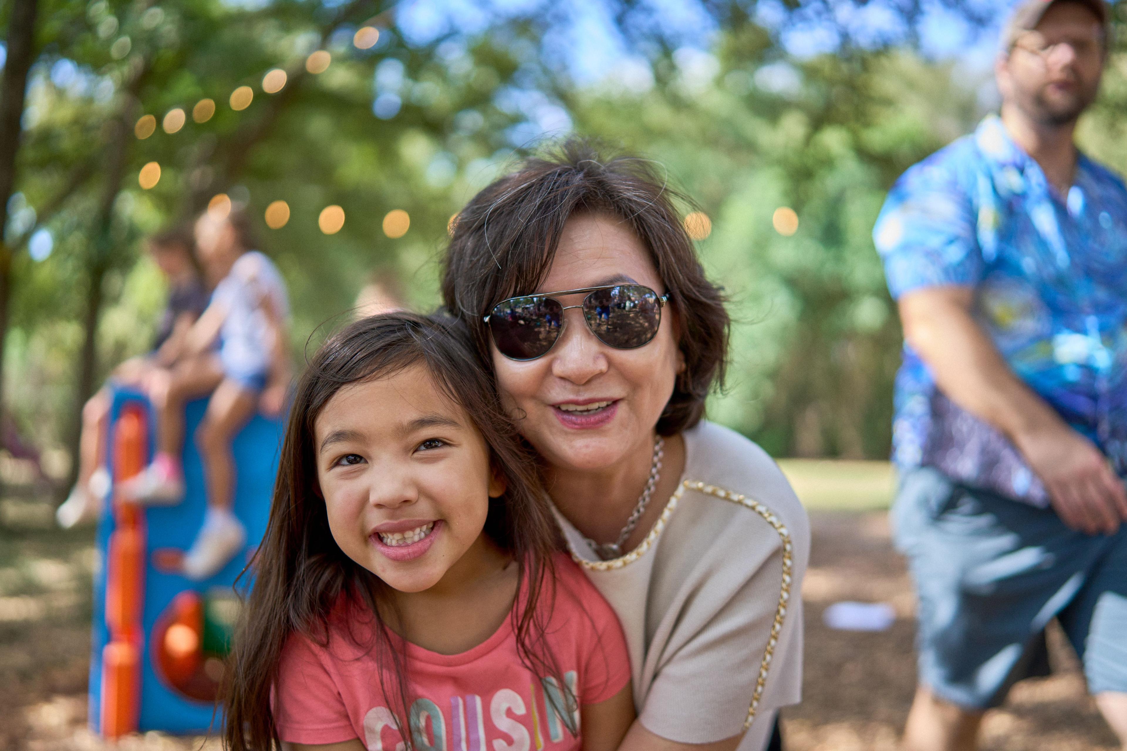 Grandmother and granddaughter cheek to cheek, both smiling at camera — Family Parties photography, Austin A grandmother and granddaughter cheek to cheek, both smiling at camera.