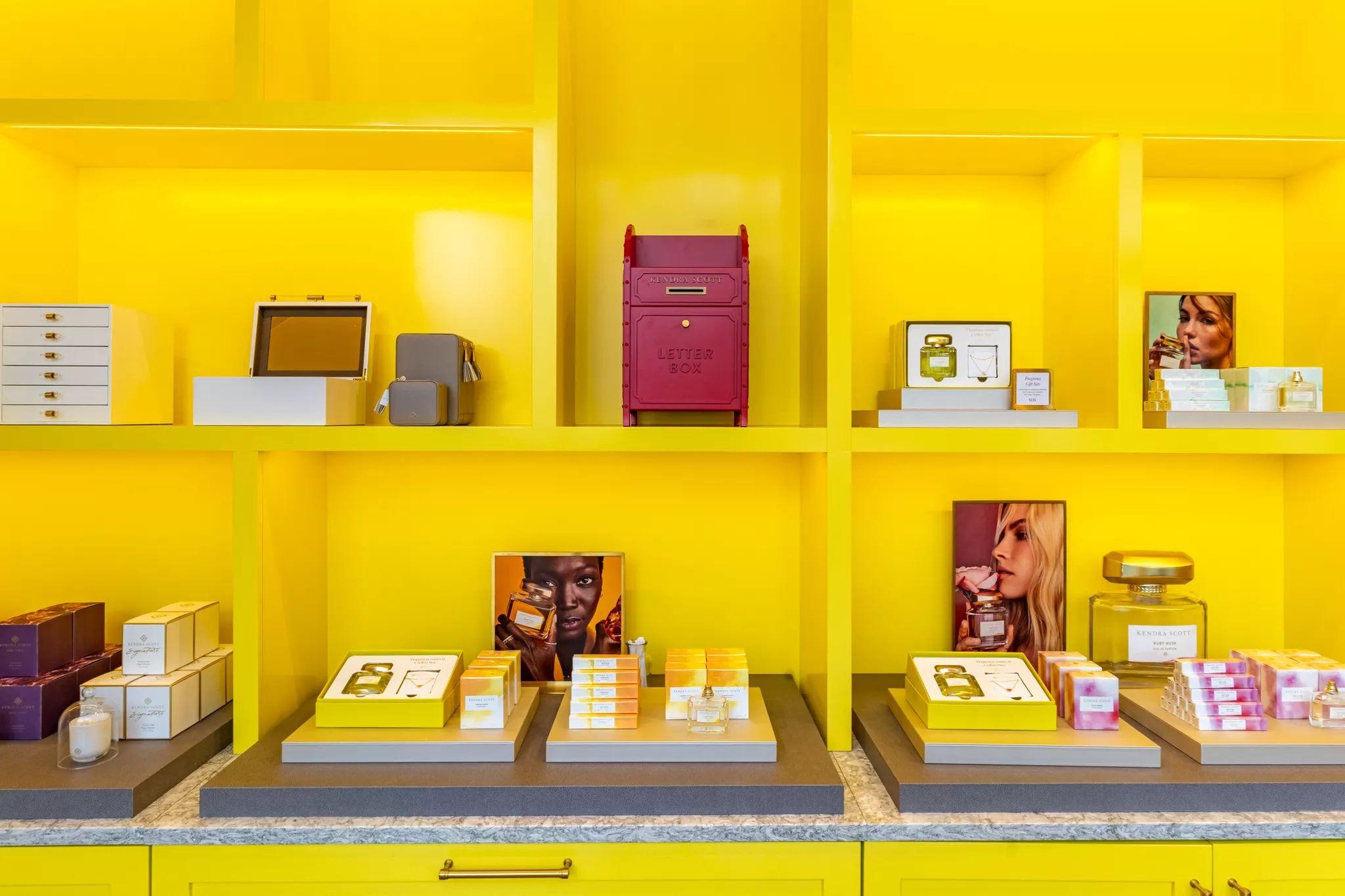Yellow retail display wall with products and a red mailbox — Brand activation photography, Austin A yellow retail display wall with products and a red mailbox.