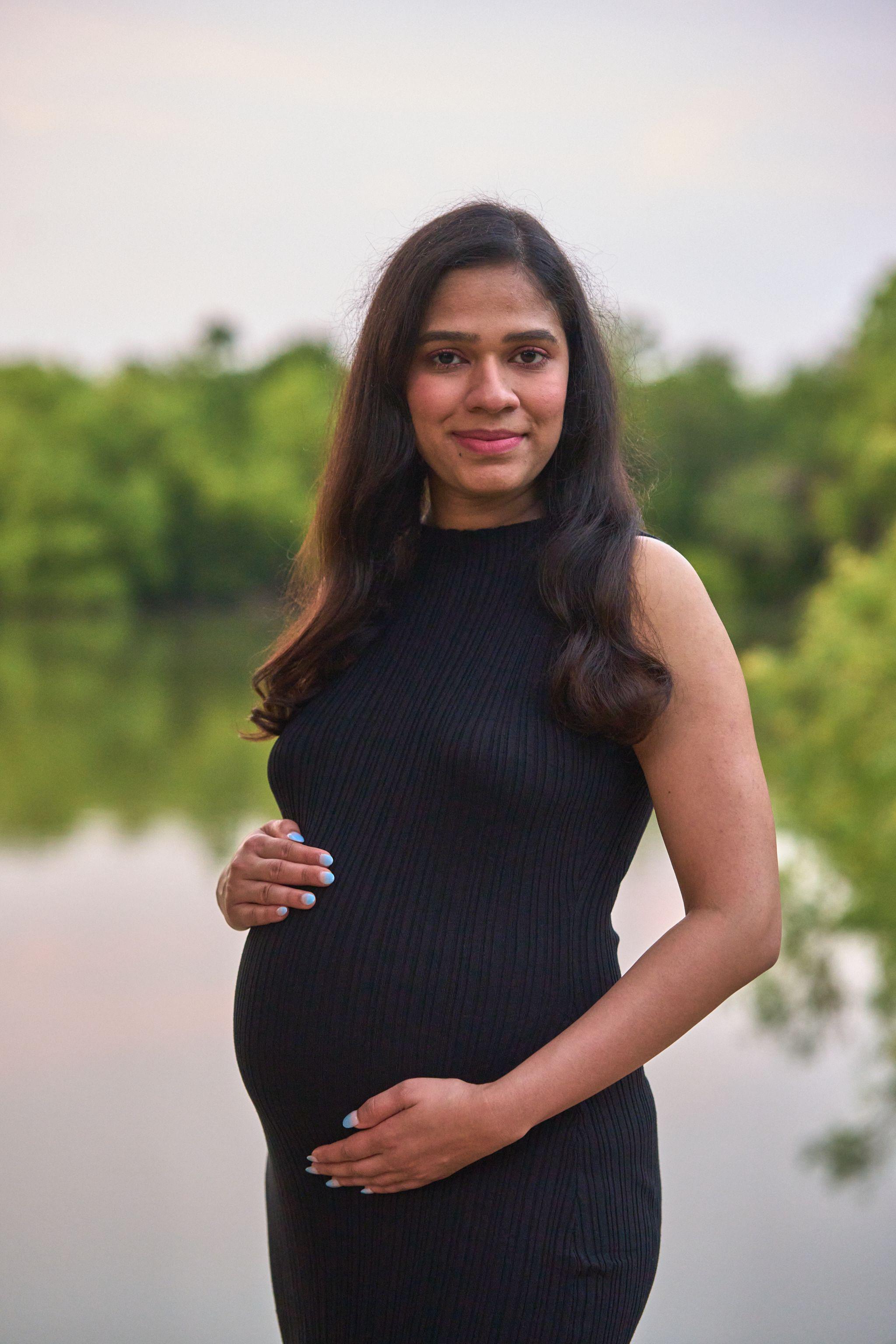 Expectant mother in a black dress beside a lake — Maternity photography, Austin Expectant mother in a black dress beside a lake