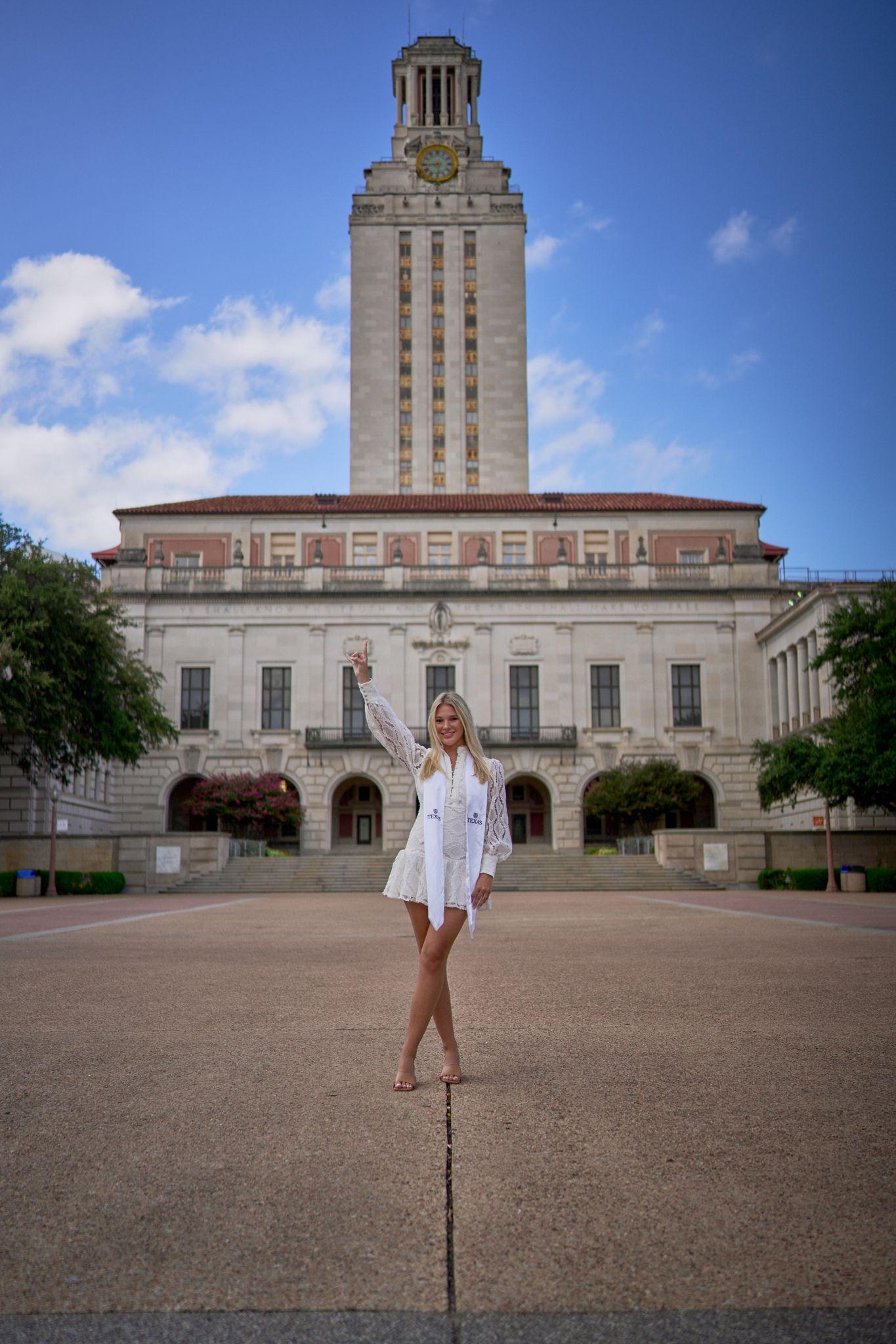 Graduate raising her arms on the empty plaza in front of the UT Tower — Graduation & Prom photography, Austin A graduate raising her arms on the empty plaza in front of the UT Tower.