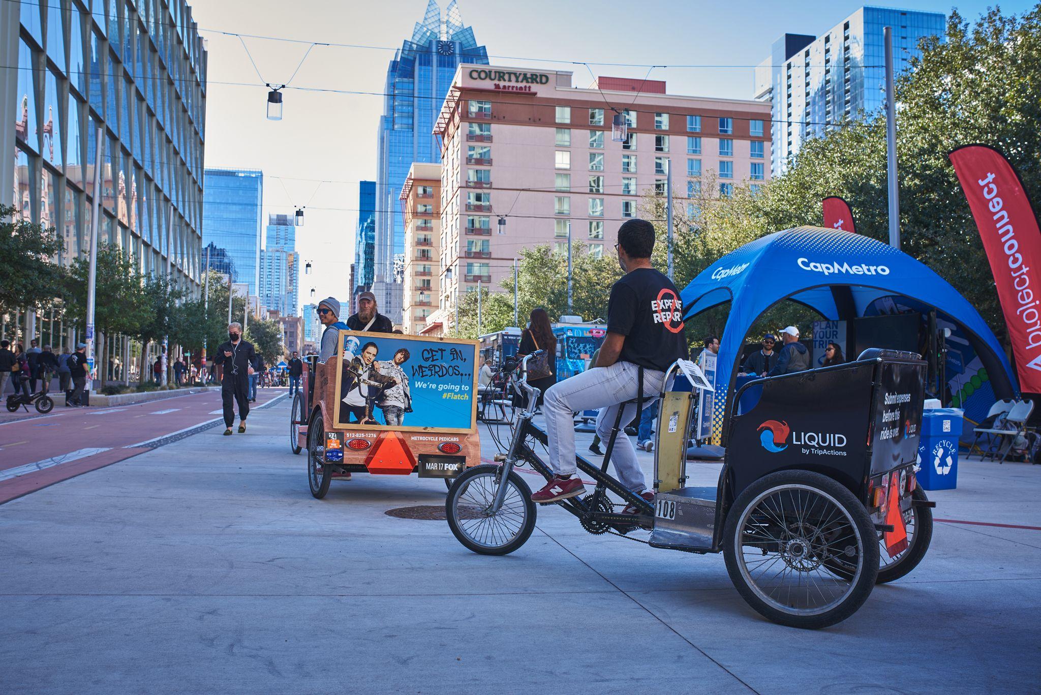 Pedicab drivers waiting for fares on a downtown Austin street, towers rising behind them — Downtown Austin photography, Austin Pedicab drivers waiting for fares on a downtown Austin street, towers rising behind them.
