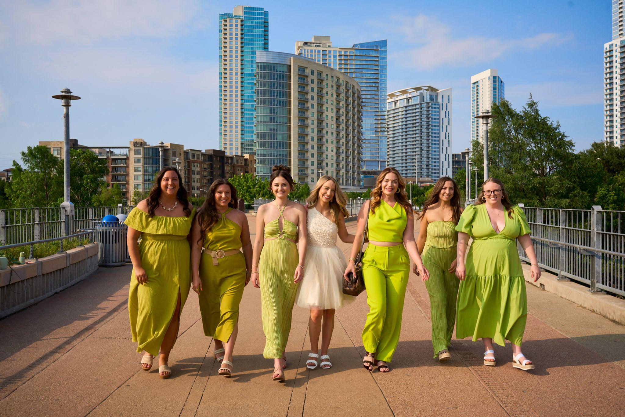 Bachelorette party dressed in green walking the full width of the Pfluger bridge deck toward — Pfluger Pedestrian Bridge photography, Austin A bachelorette party dressed in green walking the full width of the Pfluger bridge deck toward the camera