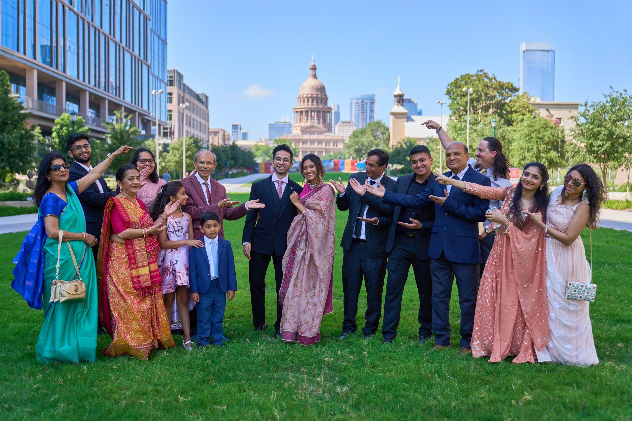 Wedding party in suits and saris applauding on the Capitol lawn after a small ceremony — Elopements photography, Austin A wedding party in suits and saris applauding on the Capitol lawn after a small ceremony.