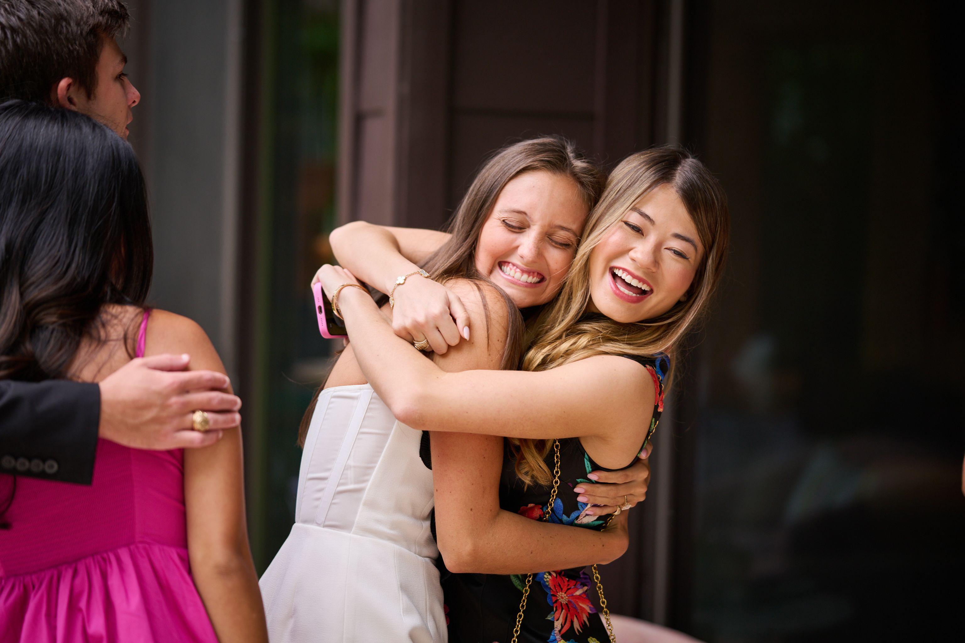 Two friends hugging and laughing at a bachelorette gathering — Bachelor & Bachelorette photography, Austin Two friends hugging and laughing at a bachelorette gathering.