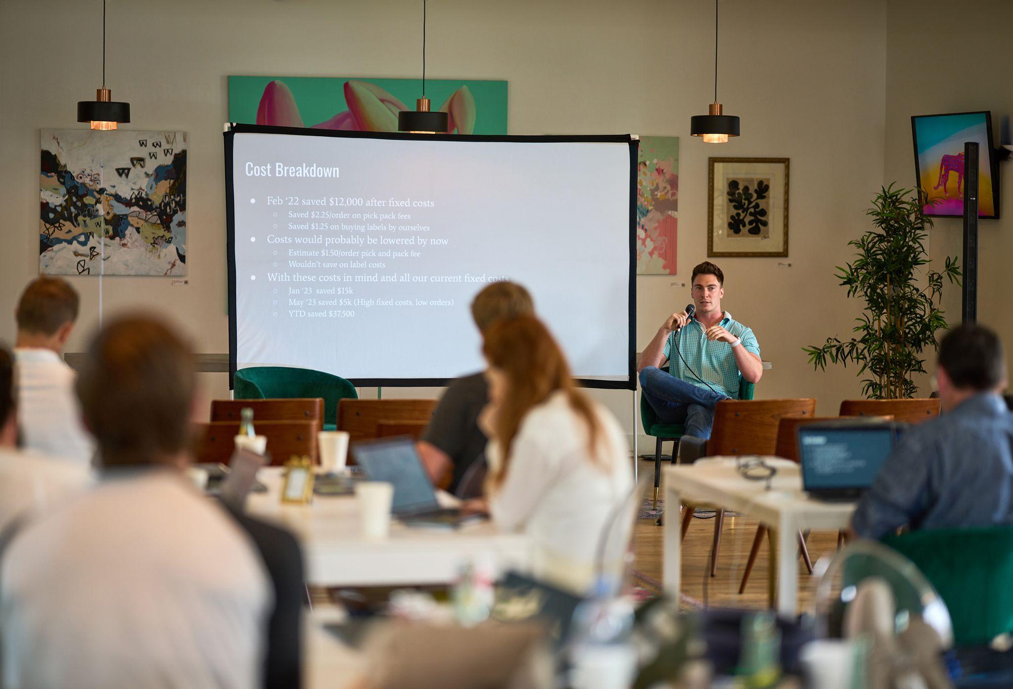Team watching a slide presentation in a bright meeting room, seen past someone — Team offsite photography, Austin A team watching a slide presentation in a bright meeting room, seen past someone in the foreground