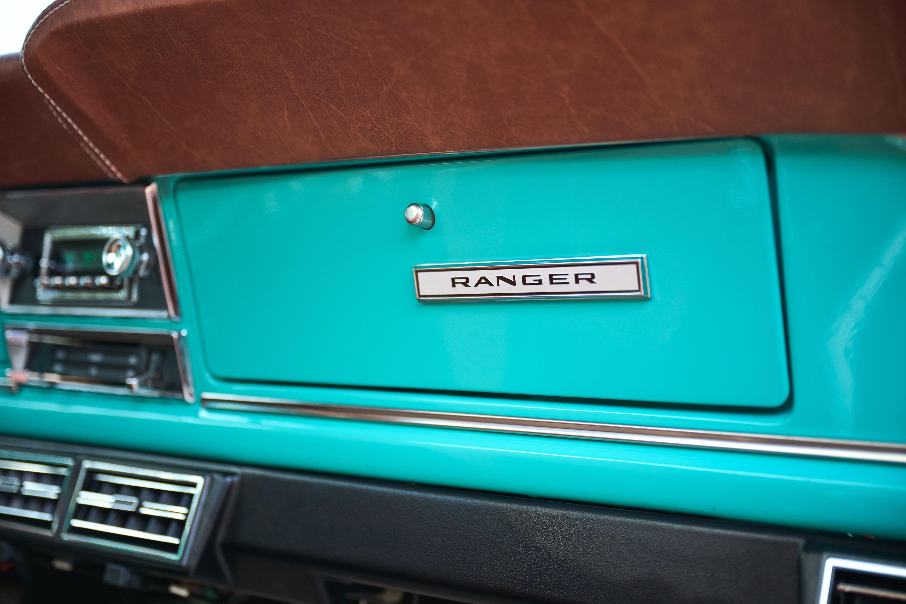 Close detail of a chrome RANGER badge on a teal tailgate — Automotive photography, Austin A close detail of a chrome RANGER badge on a teal tailgate.