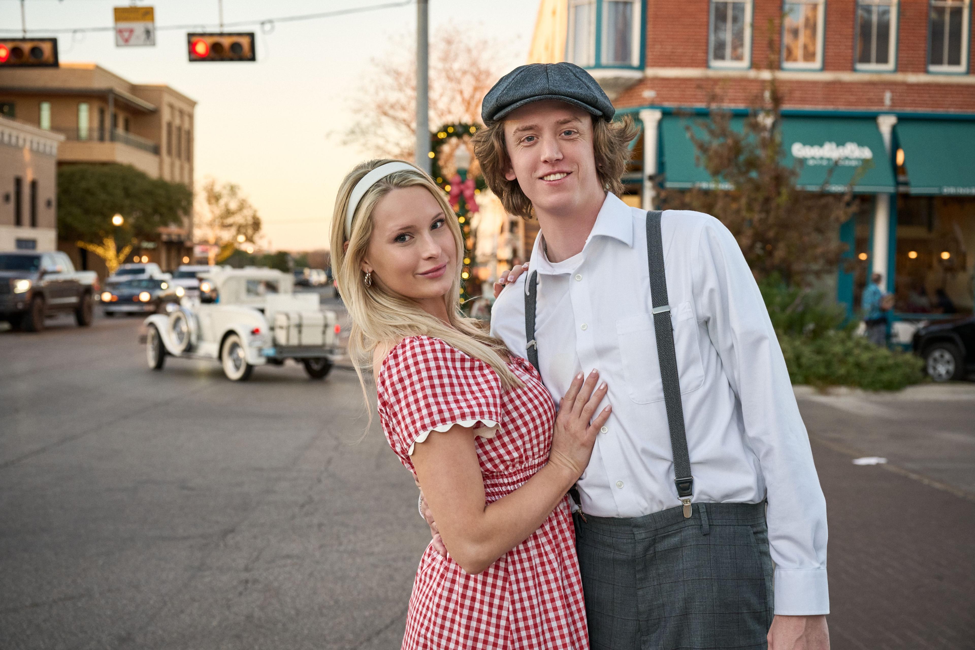 Couple in vintage dress — gingham dress and newsboy cap — on a small-town street at dusk — Georgetown Downtown photography, Austin A couple in vintage dress — gingham dress and newsboy cap — on a small-town street at dusk.
