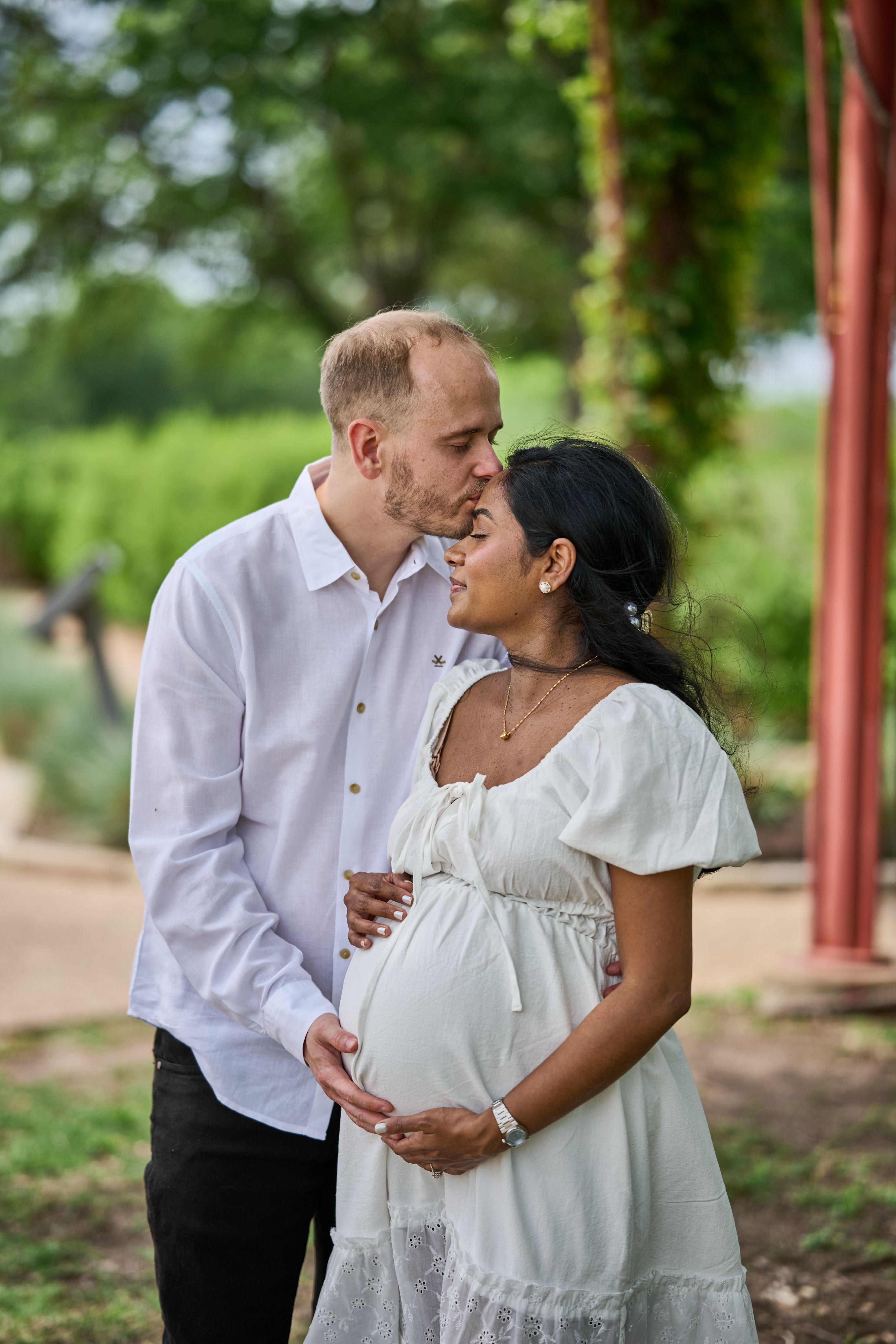 Expectant couple in a garden, mother in a white dress — Maternity photography, Austin Expectant couple in a garden, mother in a white dress