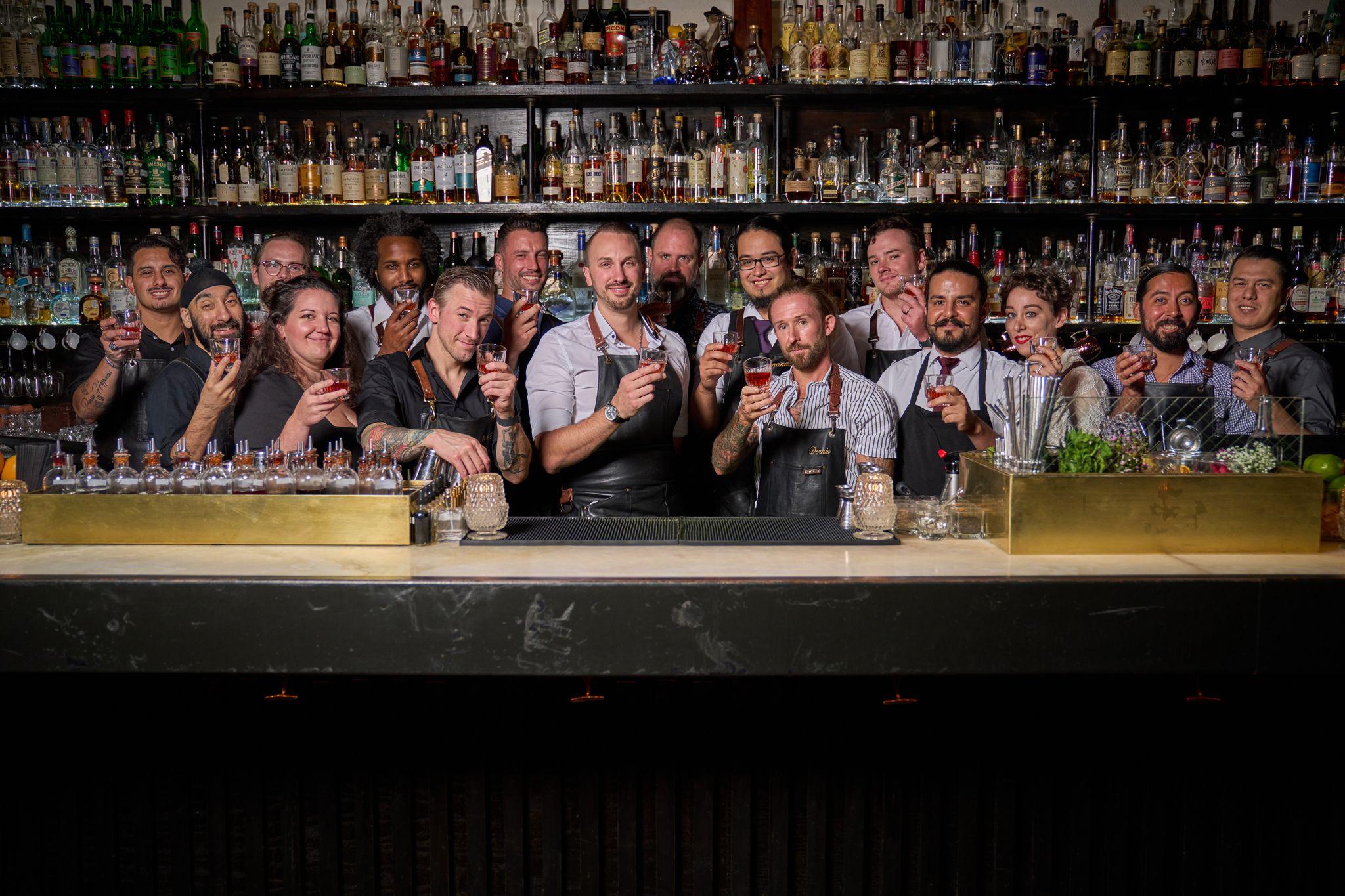 Bar team lined up behind a fully stocked back bar — Food & restaurant photography, Austin A bar team lined up behind a fully stocked back bar.
