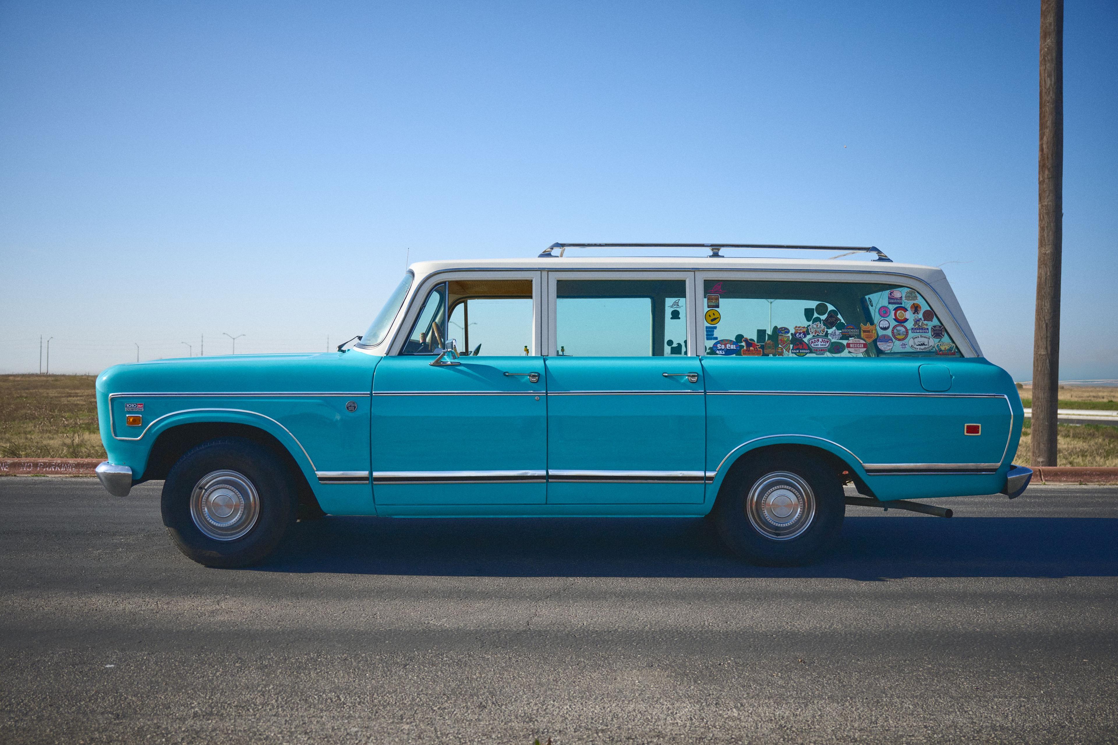 Teal vintage station wagon parked against a plain sky — Film & vintage photography, Austin A teal vintage station wagon parked against a plain sky.