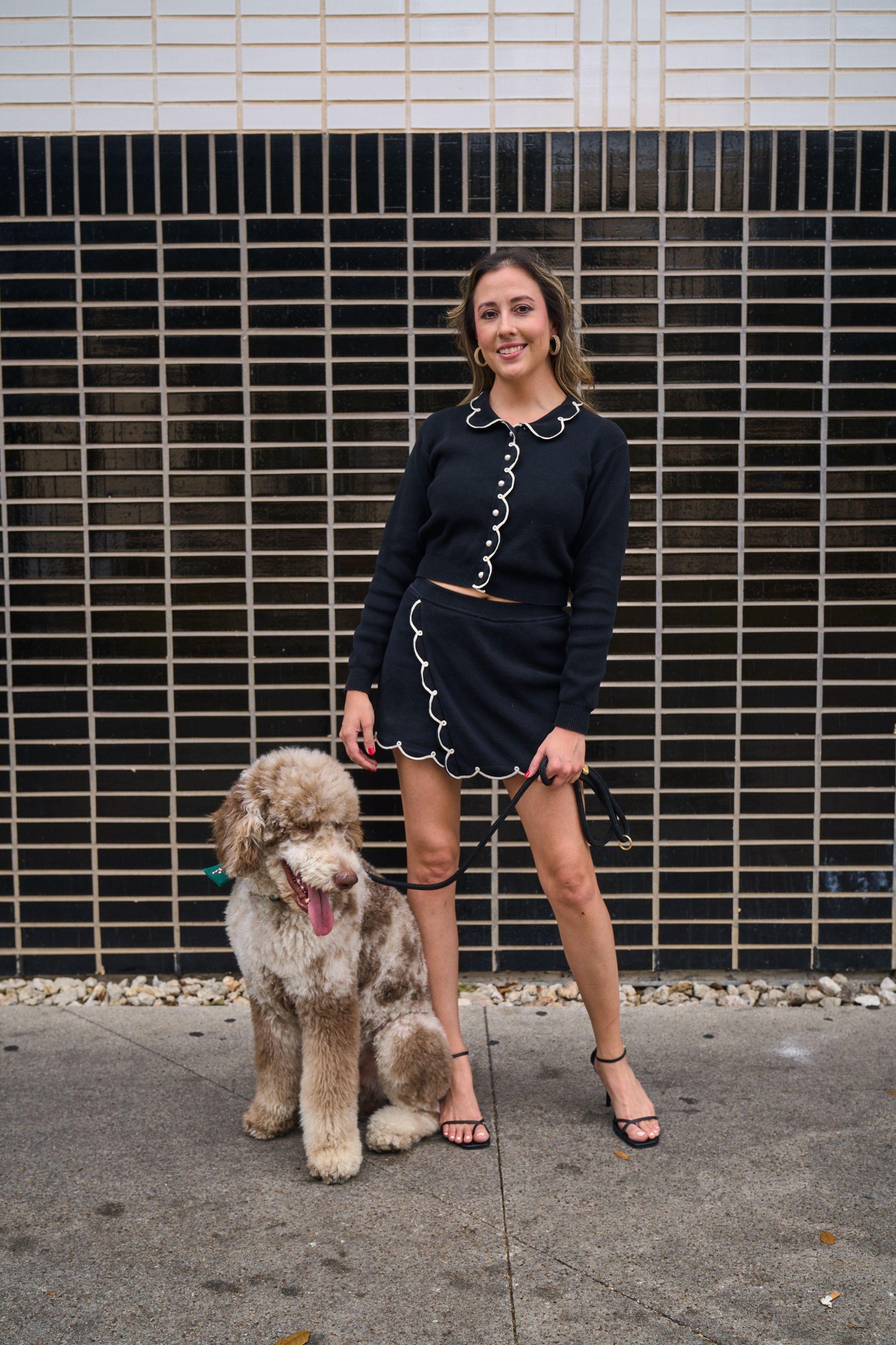 Woman and her labradoodle posed against a dark metal storefront grille — South Congress (SoCo) photography, Austin A woman and her labradoodle posed against a dark metal storefront grille.