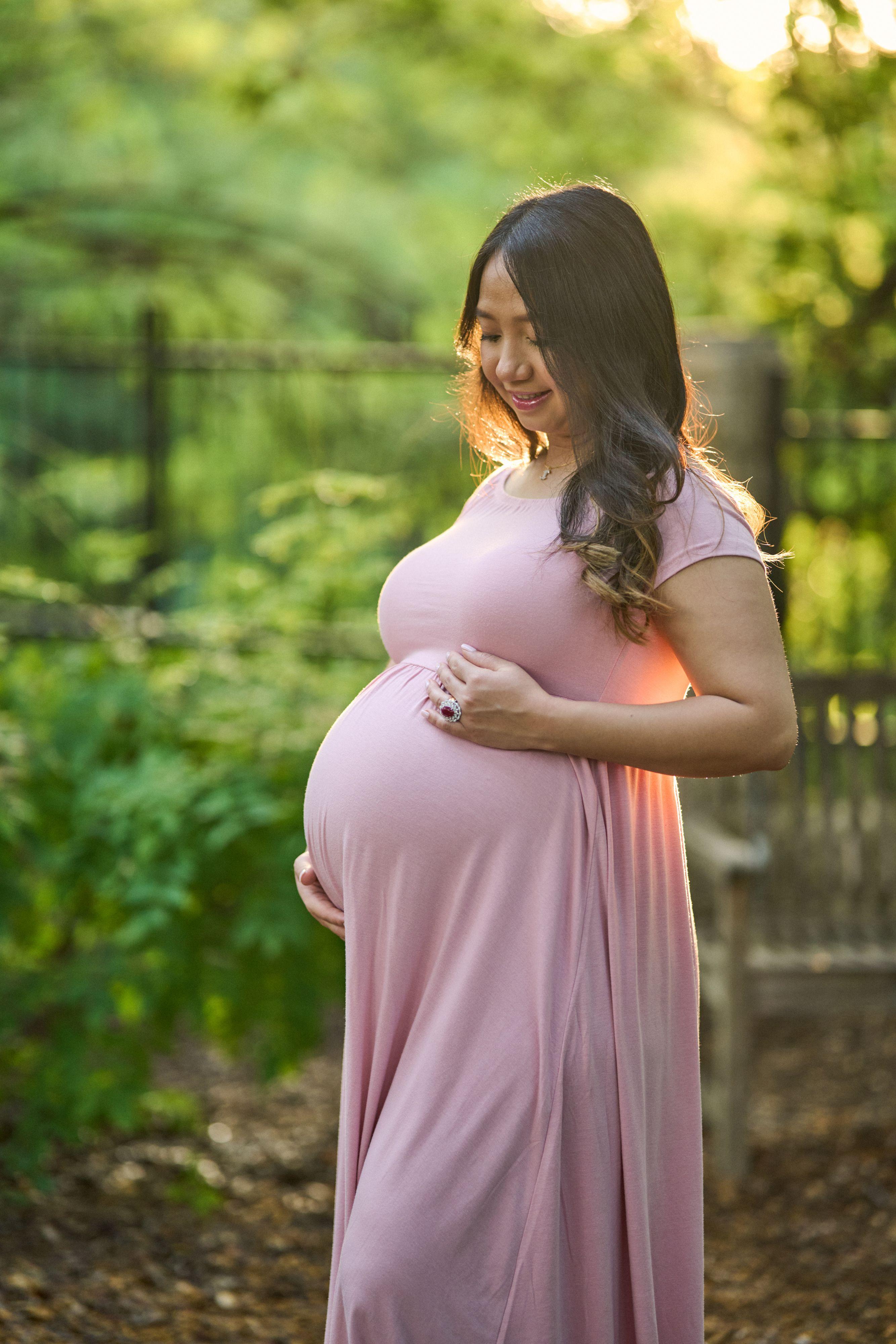 Expectant mother in a pink gown in a garden at Mayfield Park — Maternity photography, Austin Expectant mother in a pink gown in a garden at Mayfield Park
