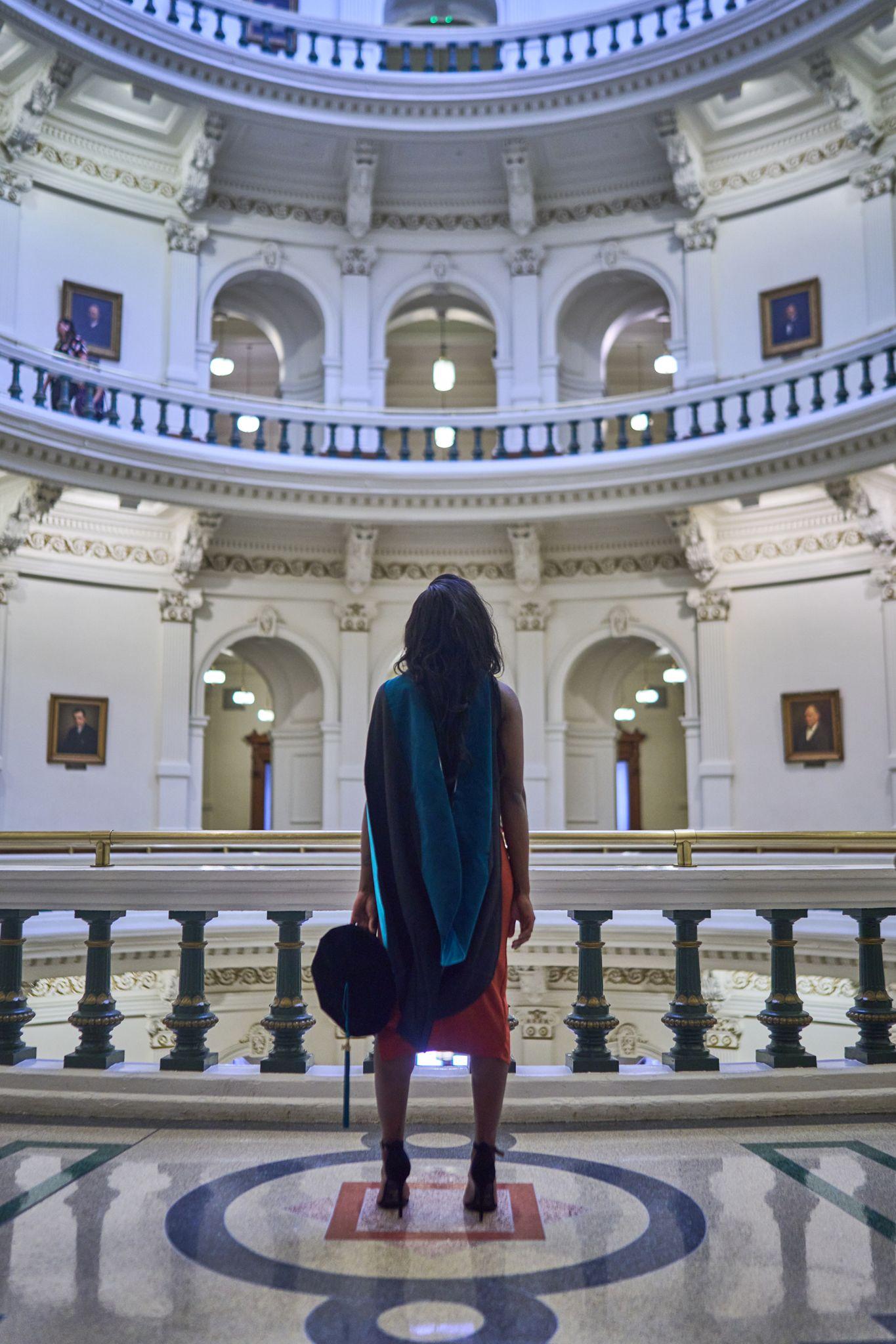 Visitor standing alone on the terrazzo star at the center of the Texas Capitol rotunda — Texas State Capitol photography, Austin A visitor standing alone on the terrazzo star at the center of the Texas Capitol rotunda.