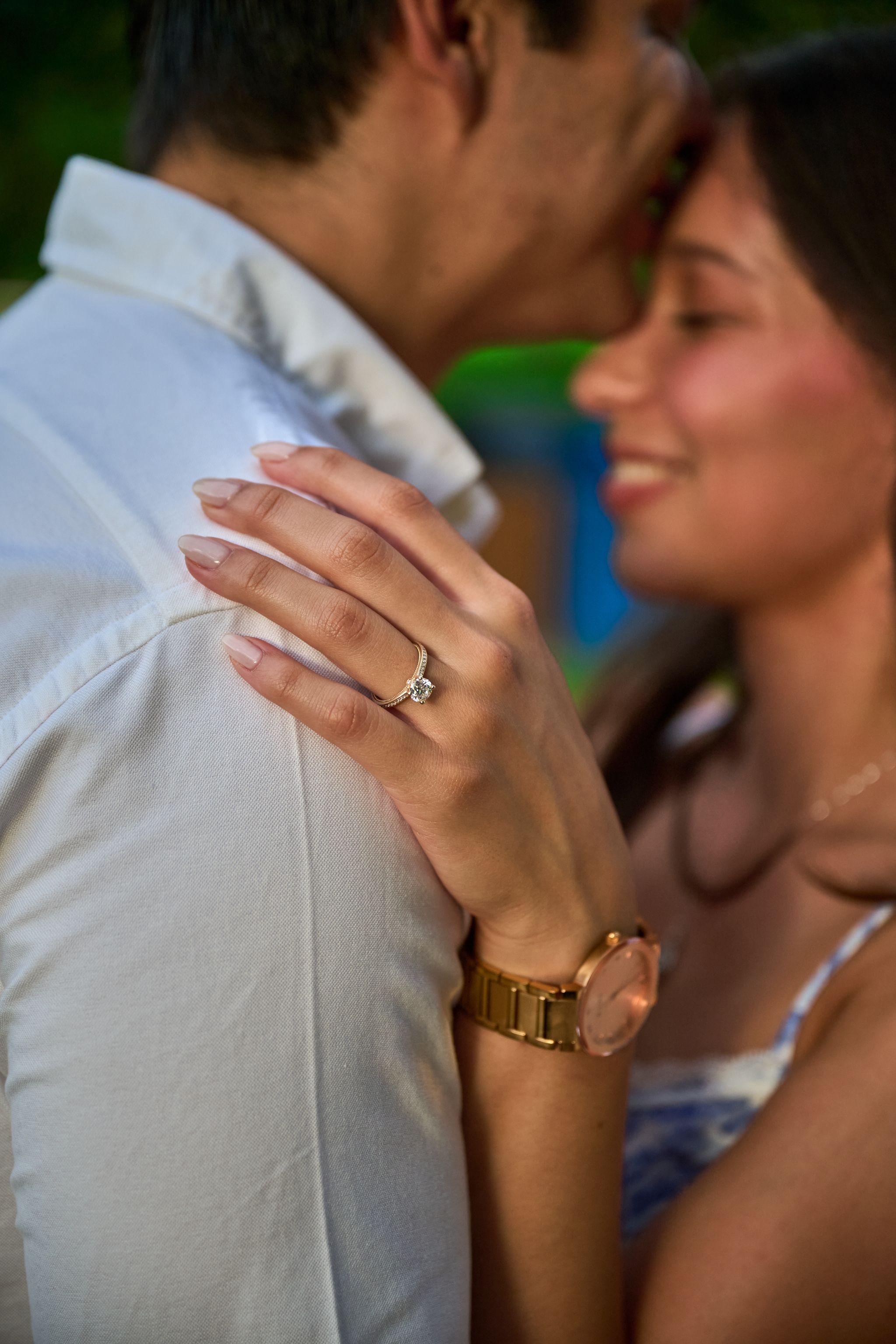 Close view of an engagement ring on a woman's hand resting on her partner's shoulder — Butler Metro Park photography, Austin A close view of an engagement ring on a woman's hand resting on her partner's shoulder.