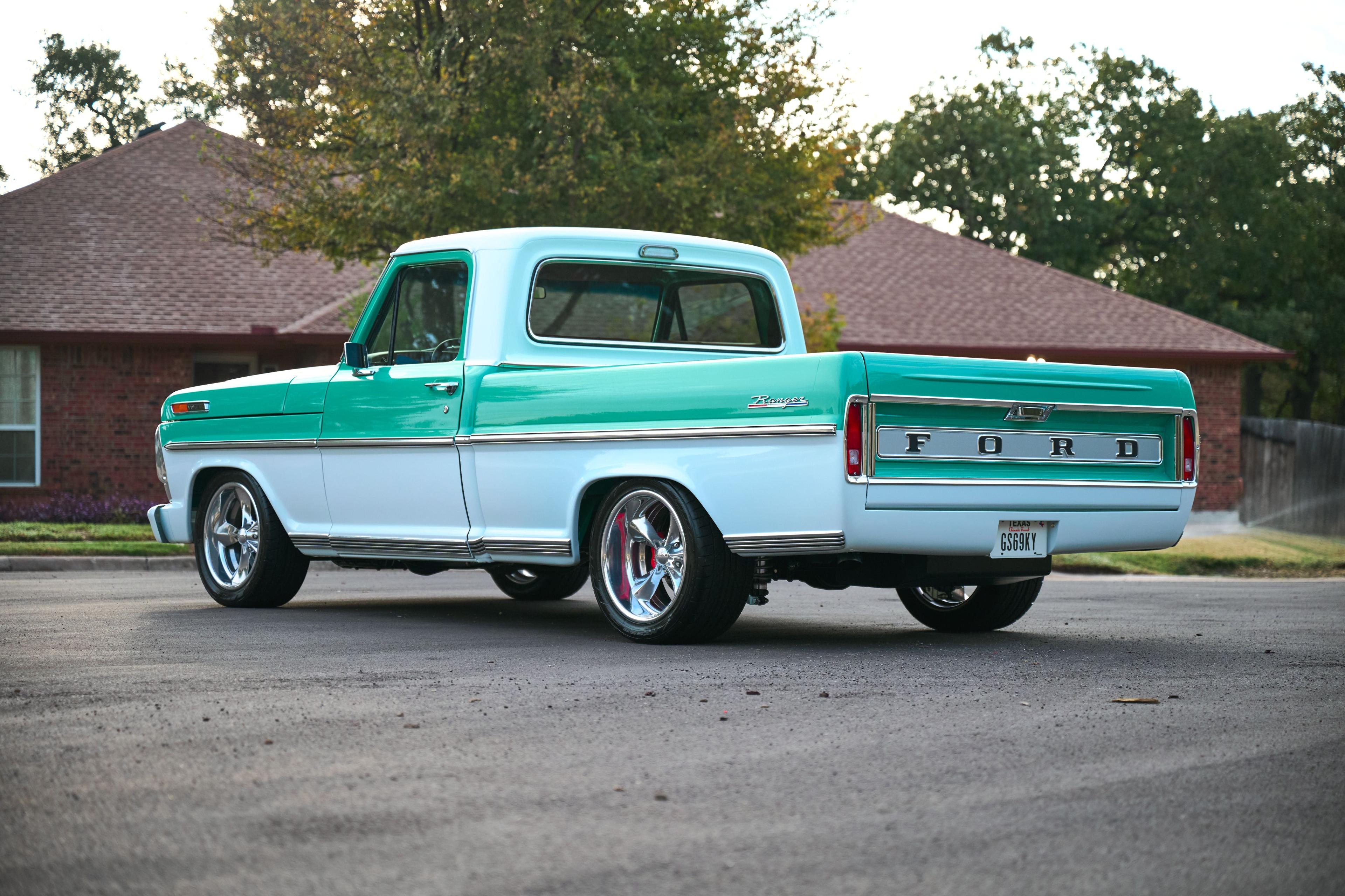 Teal and white classic Ford F-100 pickup parked on a driveway — Automotive photography, Austin A teal and white classic Ford F-100 pickup parked on a driveway.