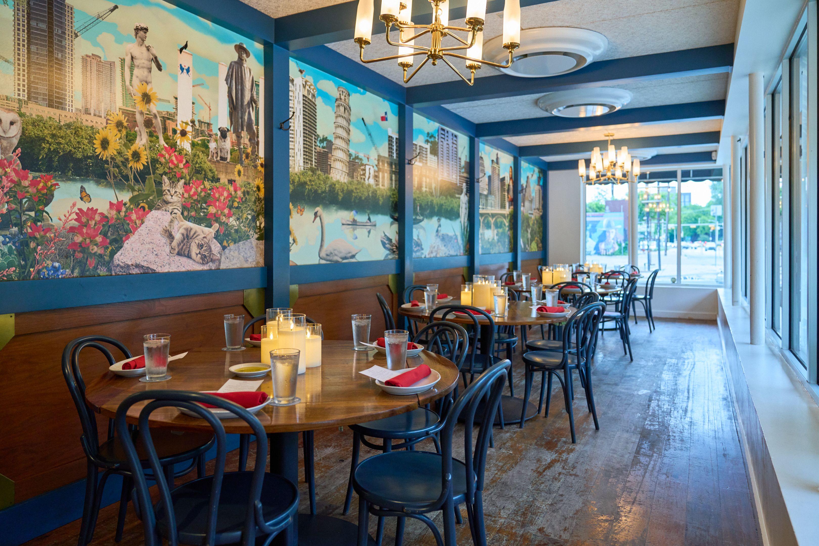 Restaurant dining room with blue walls and painted Austin skyline murals — Architectural photography, Austin A restaurant dining room with blue walls and painted Austin skyline murals.