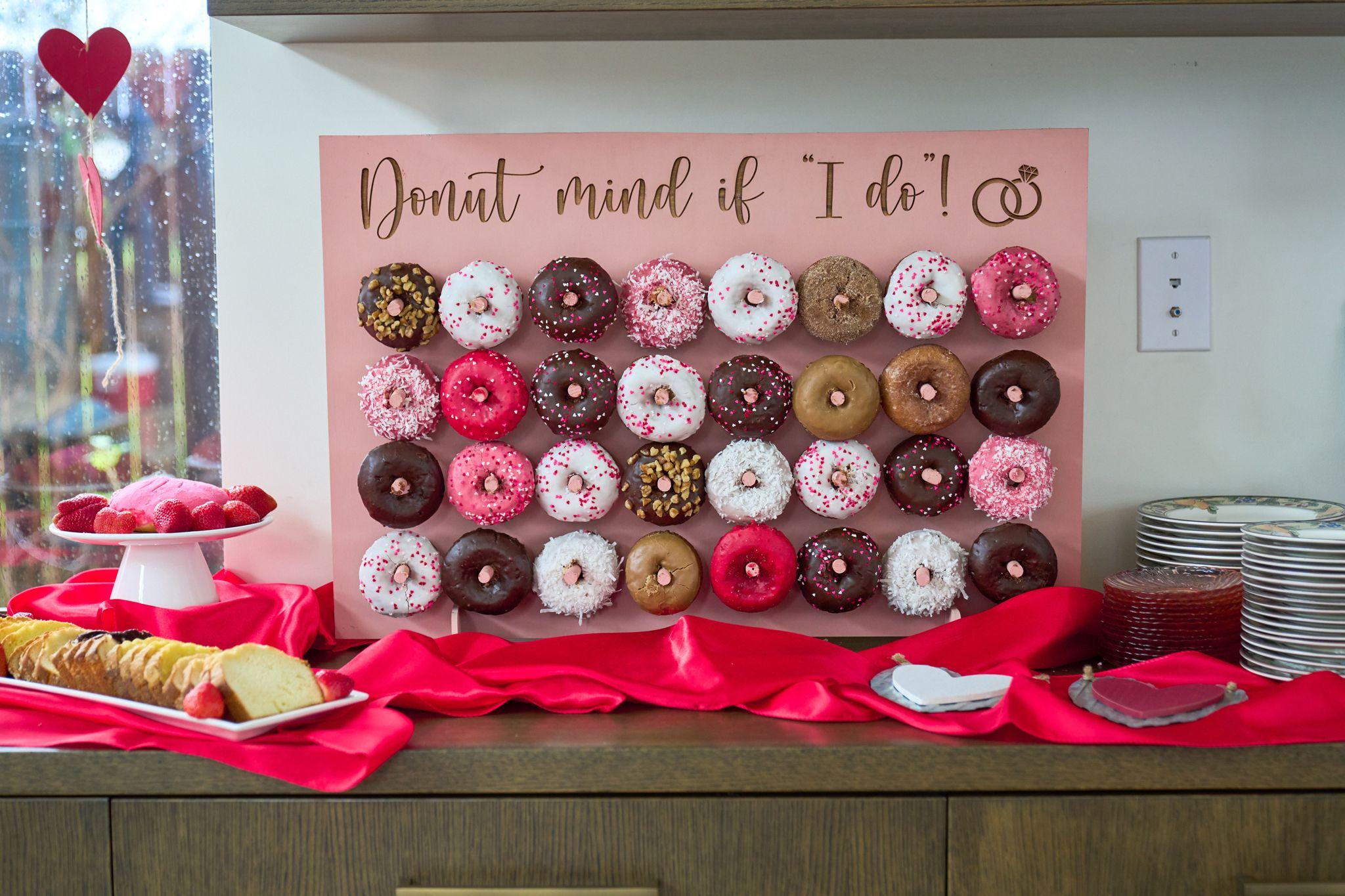 Donut wall in pink and chocolate under a sign reading 'Donut mind if I do!' — Family Parties photography, Austin A donut wall in pink and chocolate under a sign reading 'Donut mind if I do!'