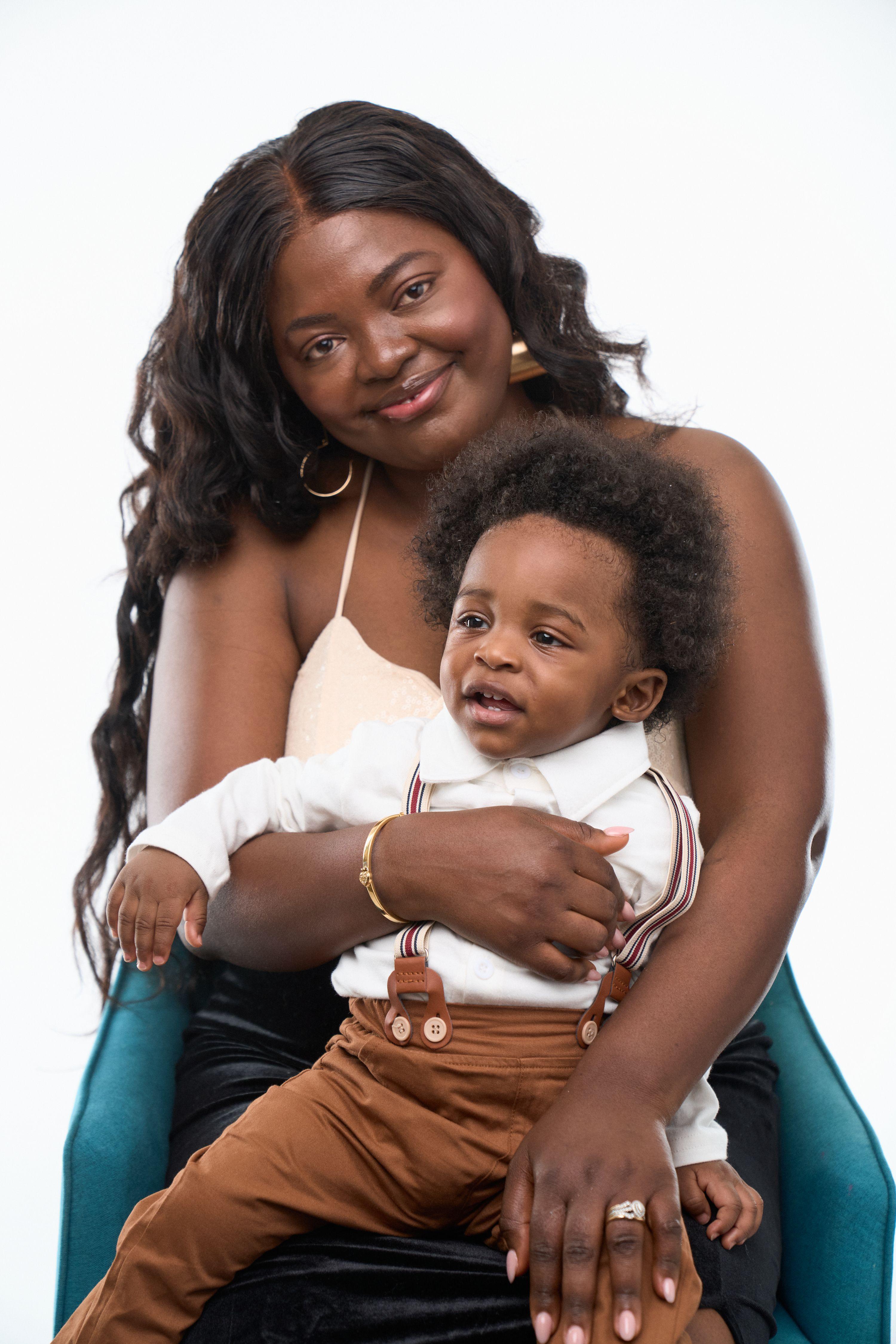 Mother seated with her baby on her lap in front of a studio backdrop — Commercial photo studio, Austin Mother seated with her baby on her lap in front of a studio backdrop