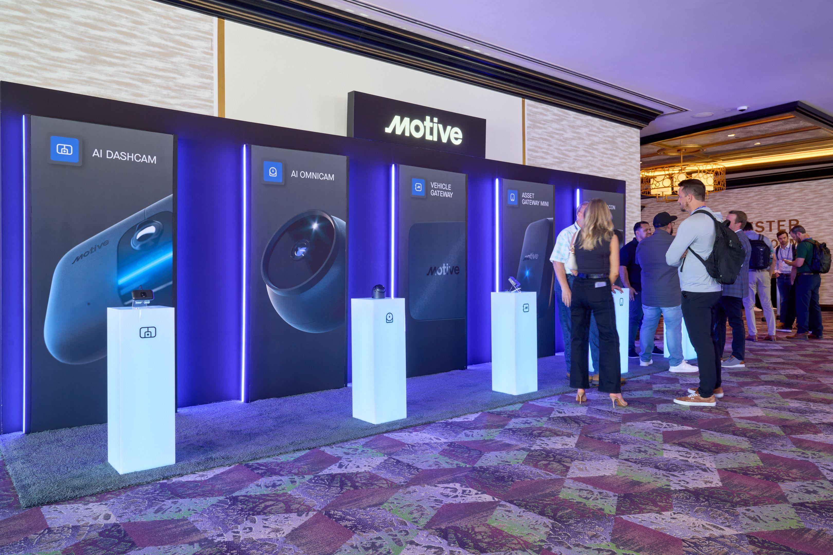 Row of lit product plinths and screens at the Motive booth on a convention expo floor — Conventions & Tradeshows photography, Austin A row of lit product plinths and screens at the Motive booth on a convention expo floor.