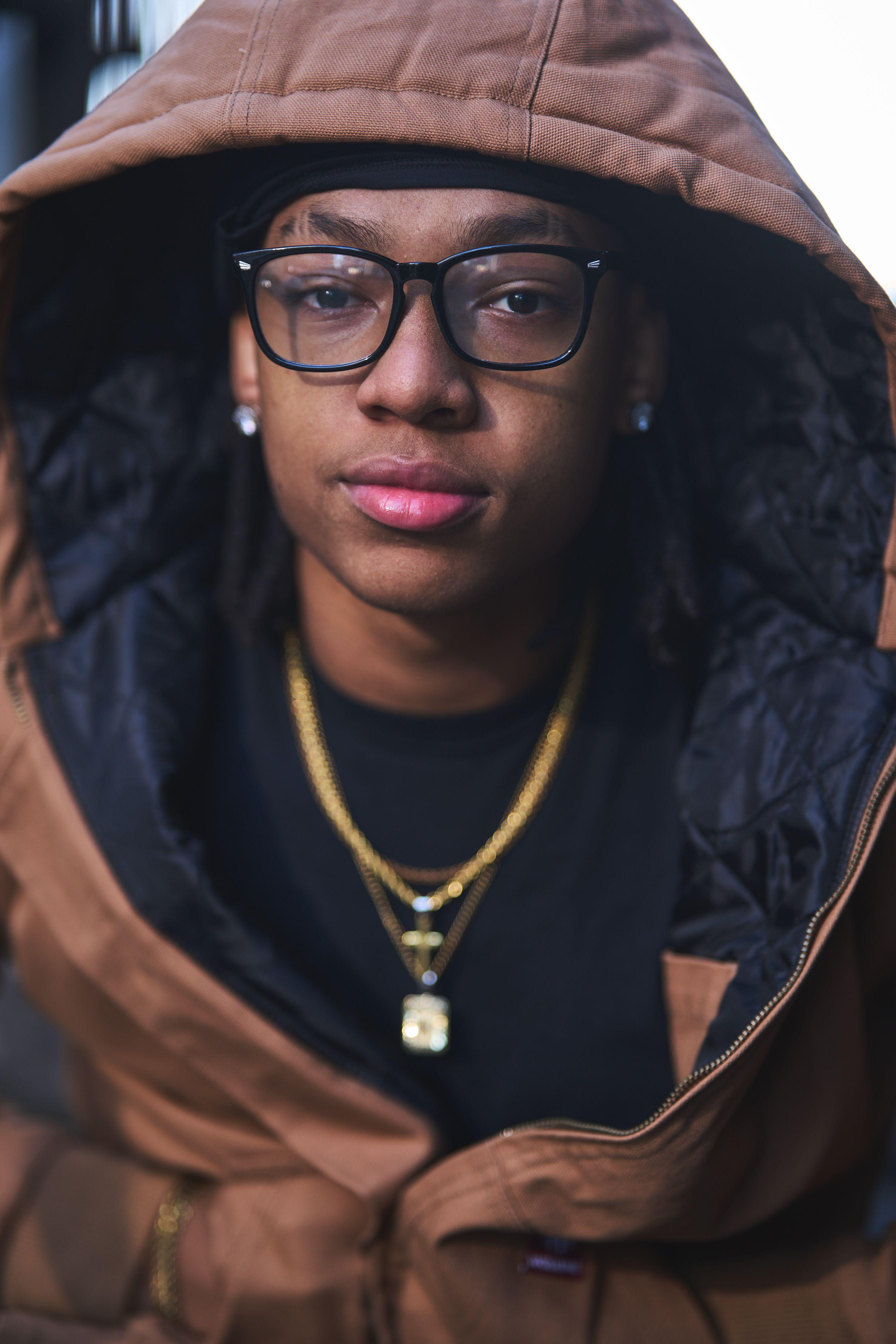 Person in glasses and a hood photographed in low-key light — Portrait photography, Austin A person in glasses and a hood photographed in low-key light.