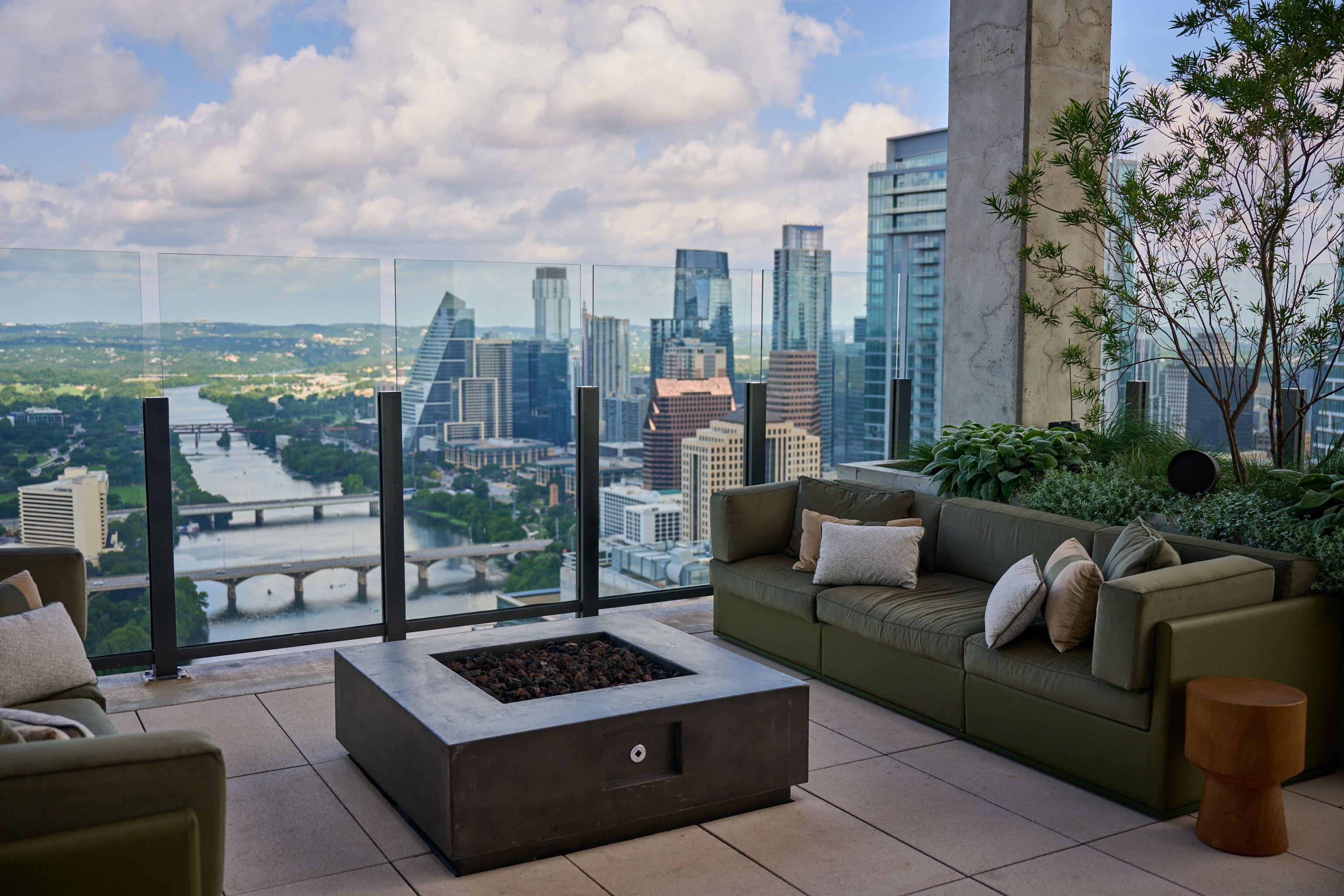 High-rise rooftop lounge with a fire pit and downtown Austin views — Architectural photography, Austin A high-rise rooftop lounge with a fire pit and downtown Austin views.