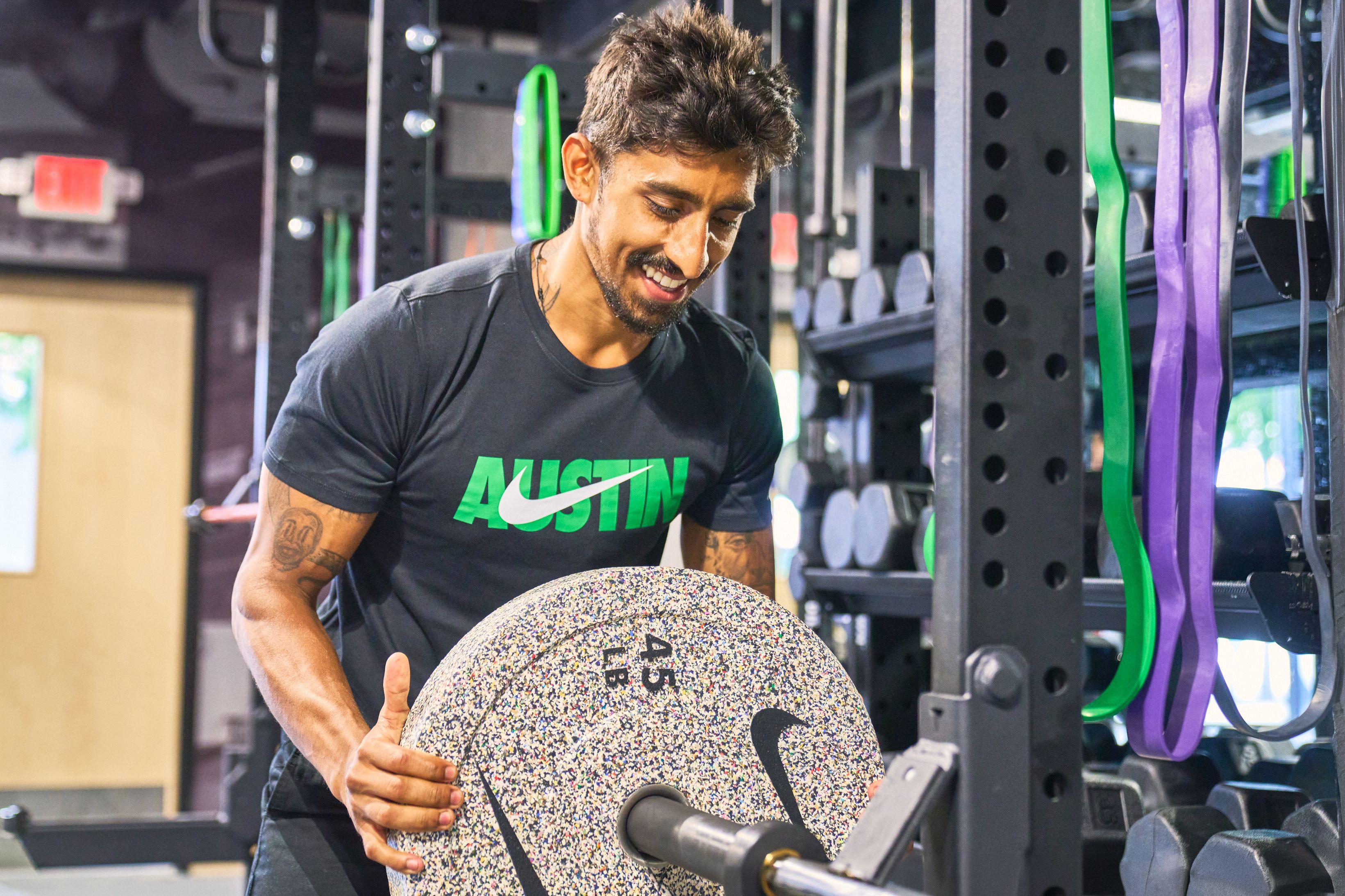 Athlete in a black tee gripping a loaded barbell in a rack, mid-set — Sports photography, Austin Athlete in a black tee gripping a loaded barbell in a rack, mid-set
