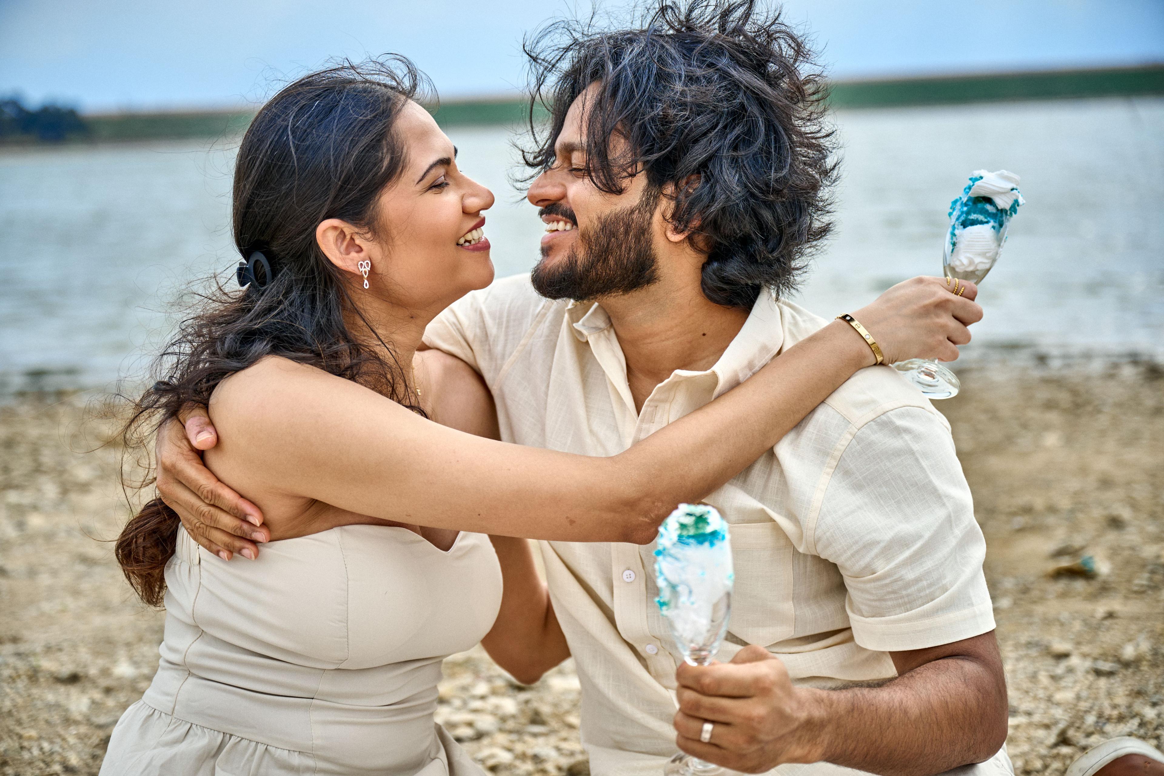 Expectant couple in beige by a lake at a gender reveal — Maternity photography, Austin Expectant couple in beige by a lake at a gender reveal