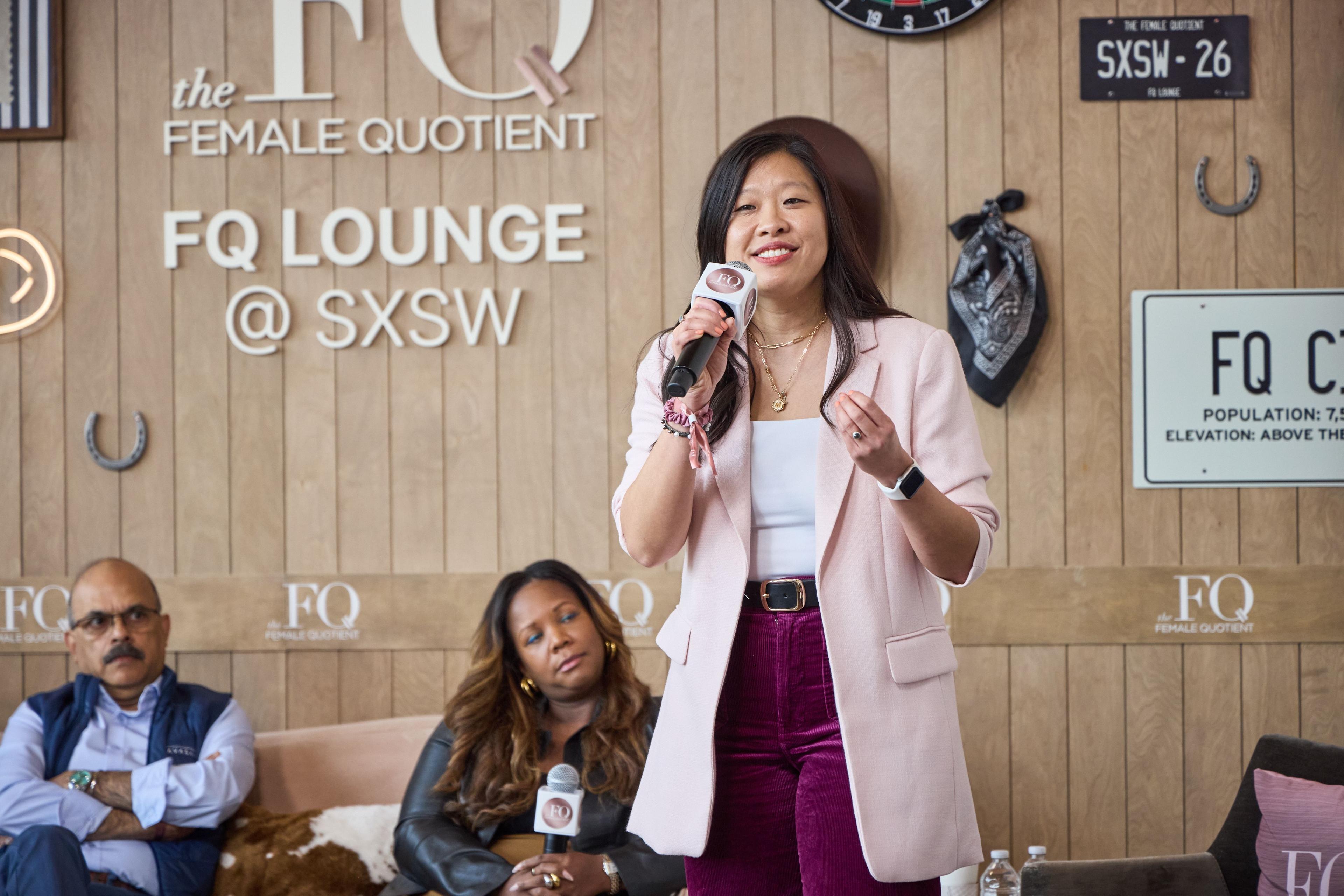 Speaker in a pale blazer presenting with a microphone at the FQ Lounge at SXSW — Conventions & Tradeshows photography, Austin A speaker in a pale blazer presenting with a microphone at the FQ Lounge at SXSW.