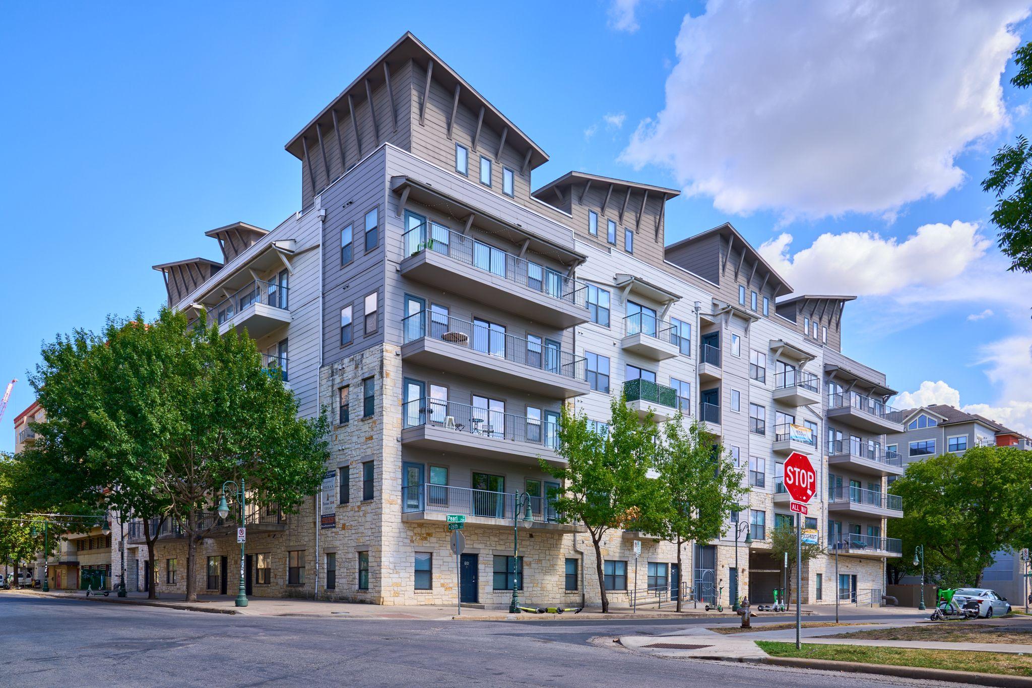 Mid-rise apartment building with balconies on a street corner — Architectural photography, Austin A mid-rise apartment building with balconies on a street corner.