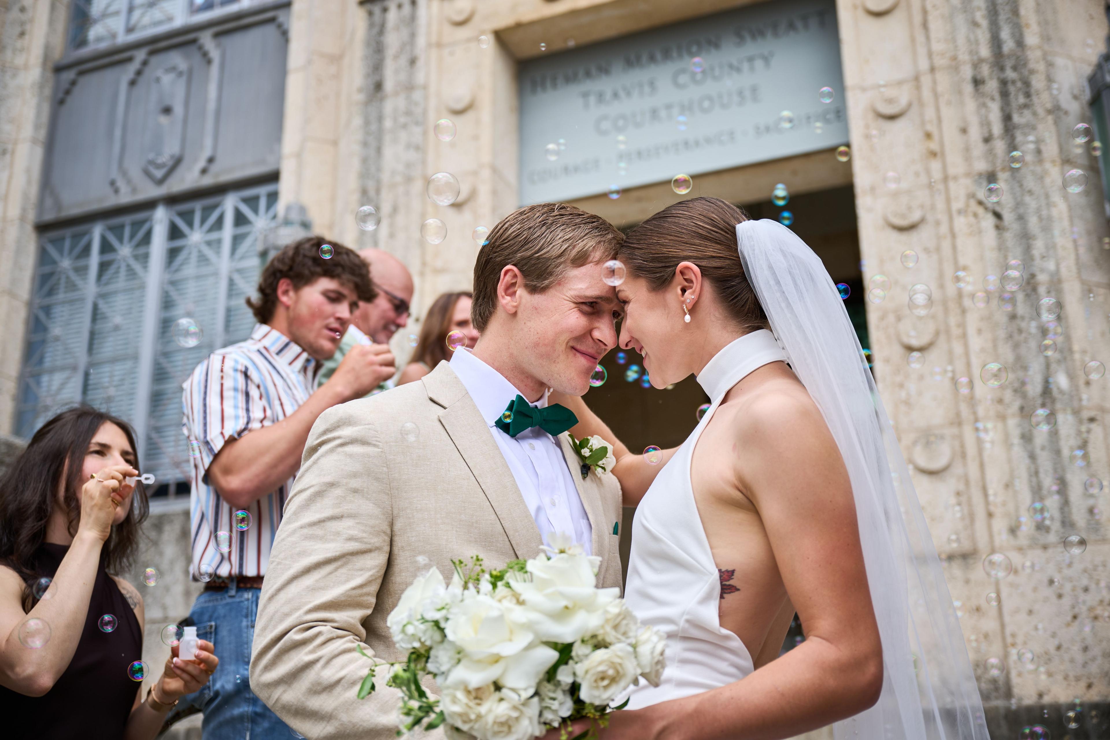 Bride and groom resting their foreheads together outside the Travis County courthouse — Weddings photography, Austin A bride and groom resting their foreheads together outside the Travis County courthouse.