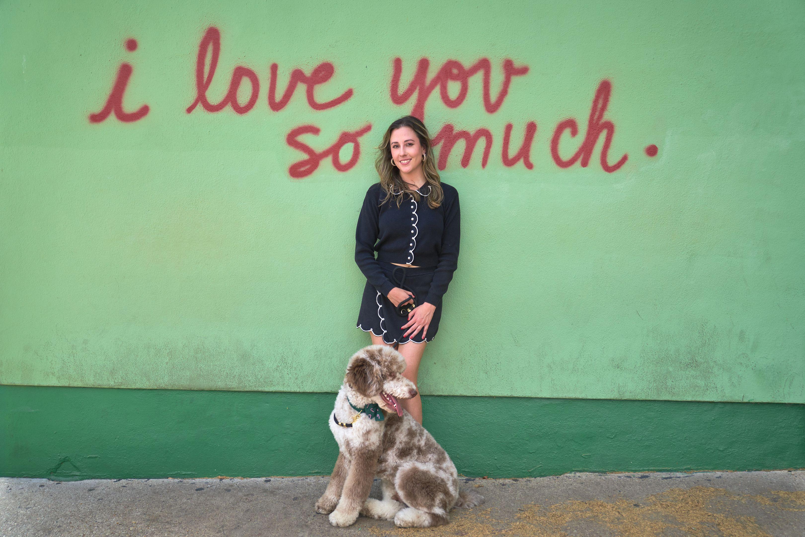 Woman and her labradoodle in front of the 'i love you so much' mural — South Congress (SoCo) photography, Austin A woman and her labradoodle in front of the 'i love you so much' mural.