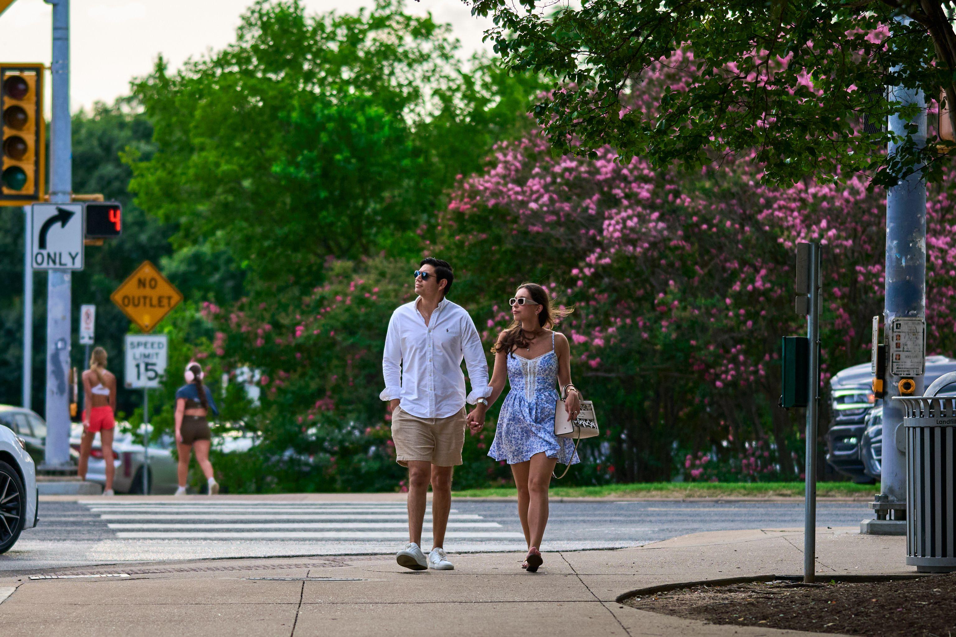 Couple walking together along a park path past crape myrtle blossom — Butler Metro Park photography, Austin A couple walking together along a park path past crape myrtle blossom.