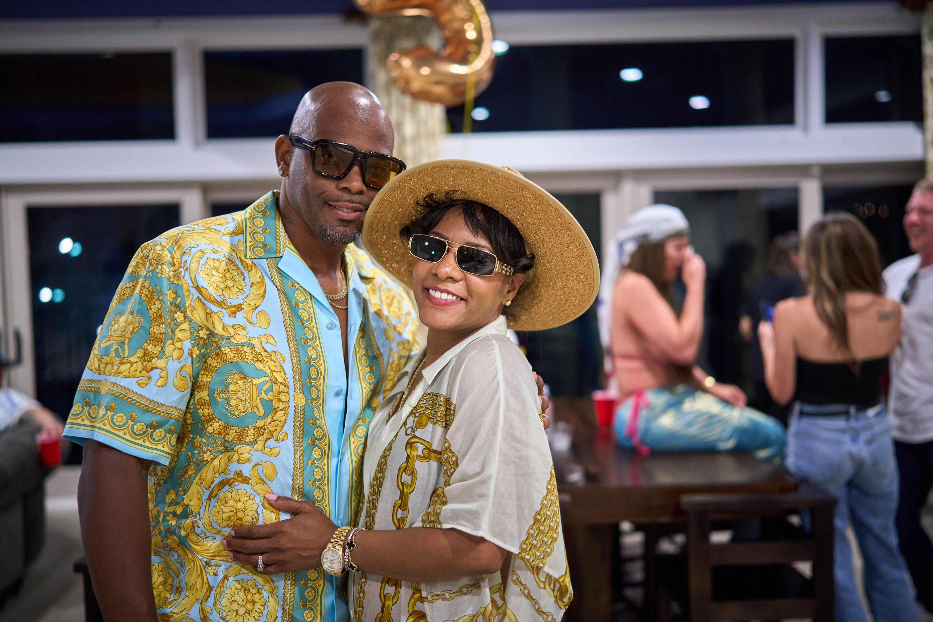 Couple in matching patterned shirts at an outdoor party with gold balloons — Party & nightlife photography, Austin A couple in matching patterned shirts at an outdoor party with gold balloons.