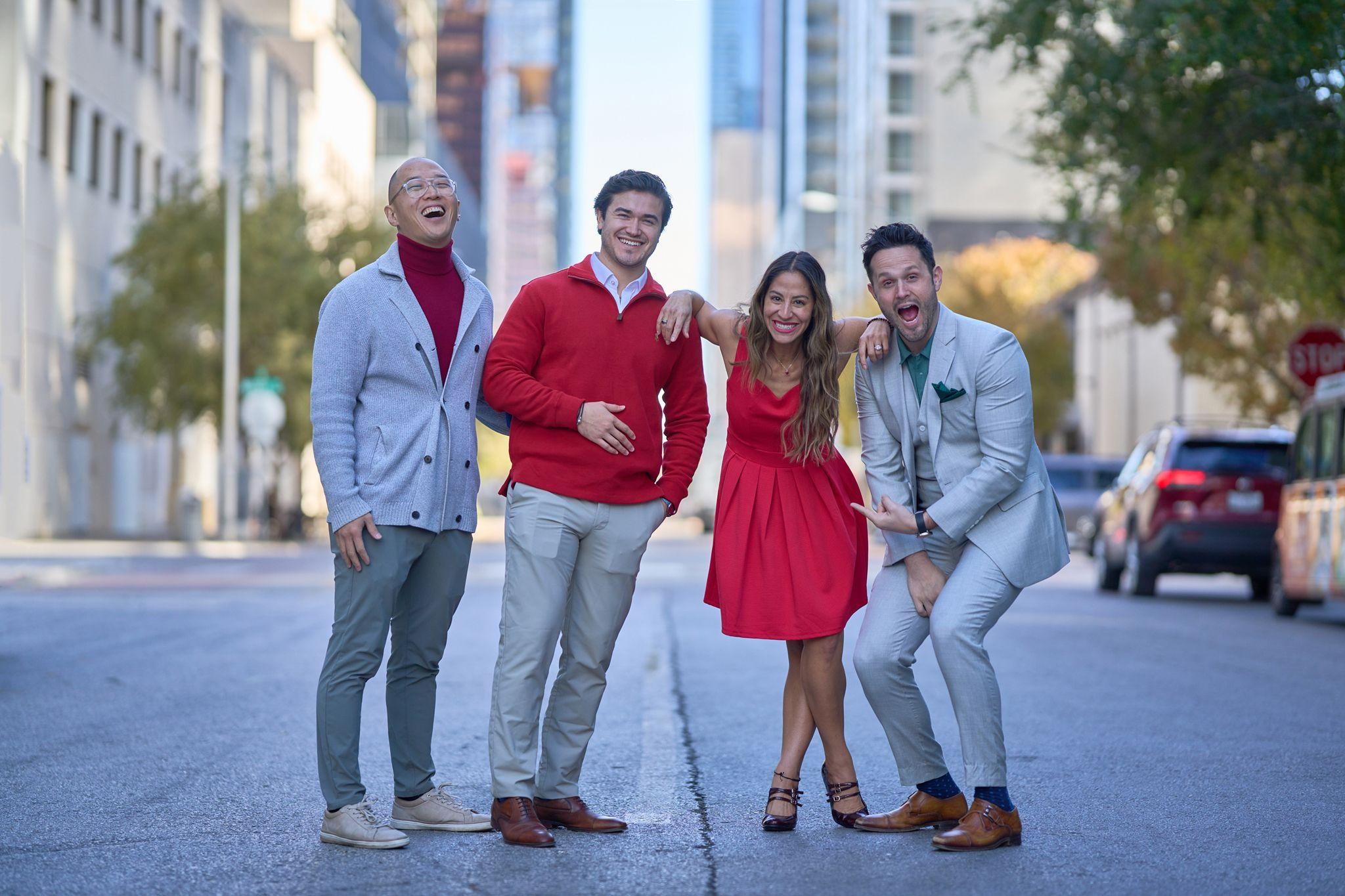 Four colleagues laughing together outdoors on a city street — Downtown Austin photography, Austin Four colleagues laughing together outdoors on a city street