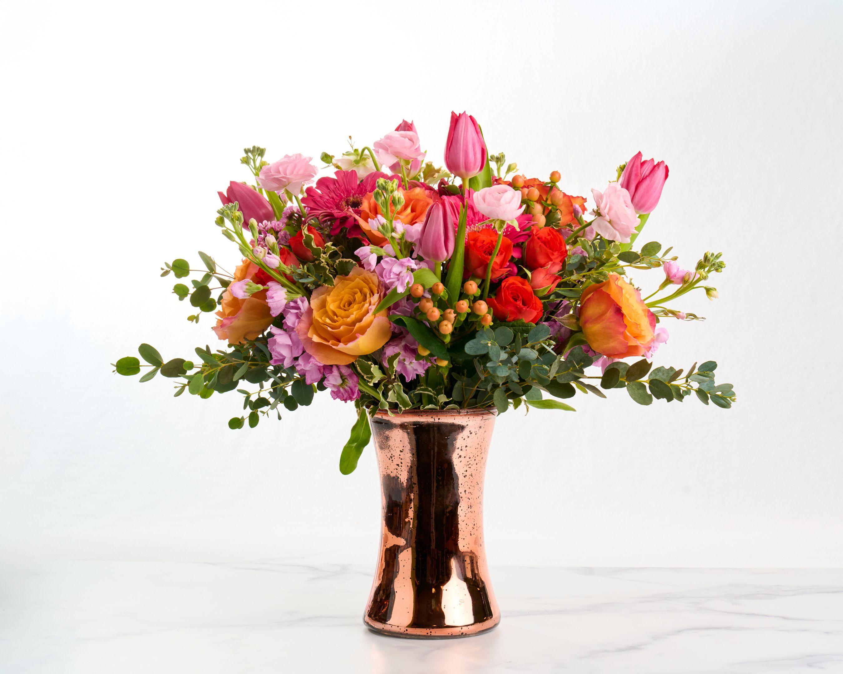 Bright floral arrangement of tulips, roses and gerberas in a copper vase on white marble — E-commerce & apparel photography, Austin Bright floral arrangement of tulips, roses and gerberas in a copper vase on white marble