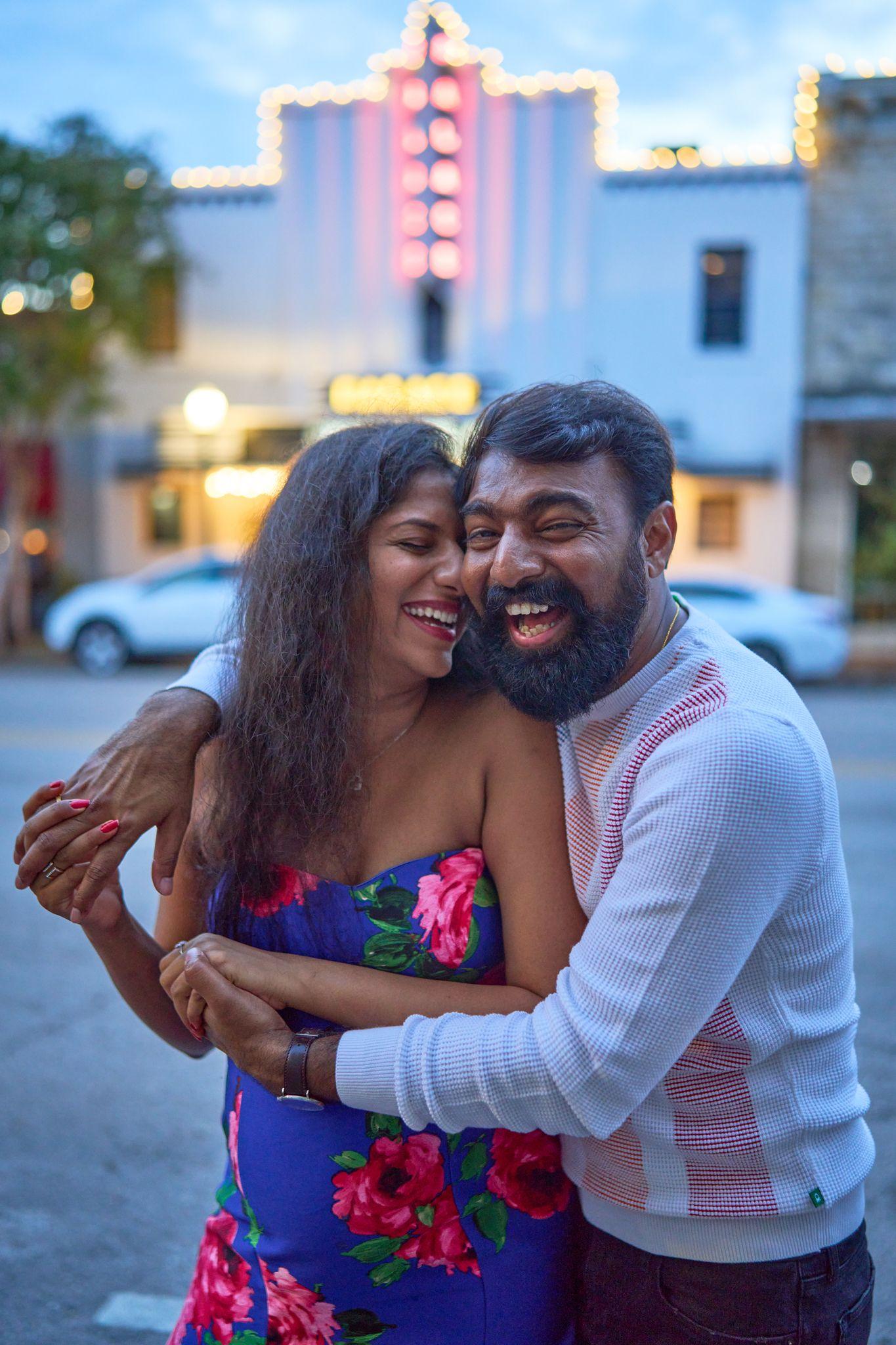 Expectant couple embracing on a city street at dusk — Georgetown Downtown photography, Austin Expectant couple embracing on a city street at dusk