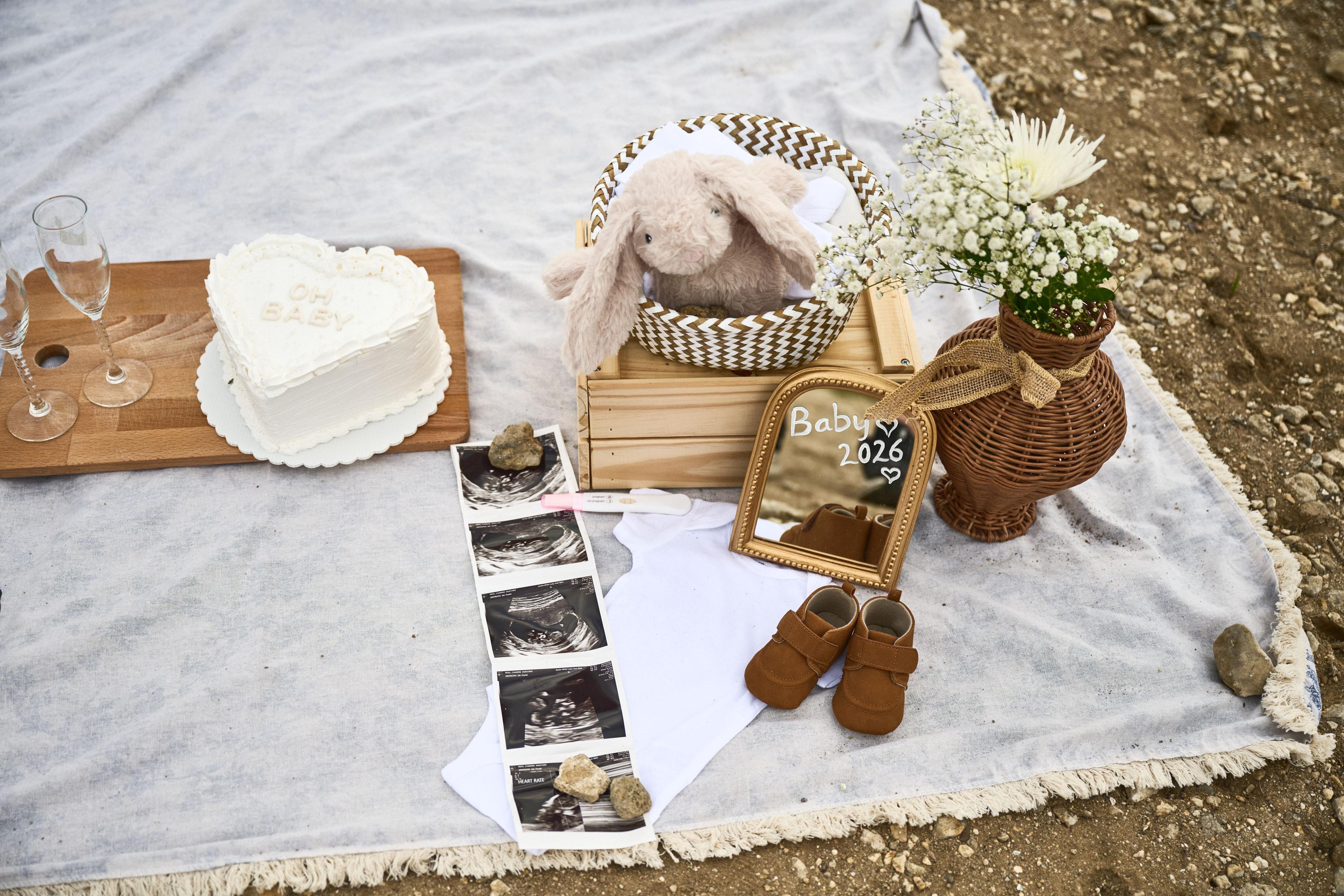 Flat-lay announcement with baby shoes, a sonogram, and a 2026 sign — Maternity photography, Austin Flat-lay announcement with baby shoes, a sonogram, and a 2026 sign