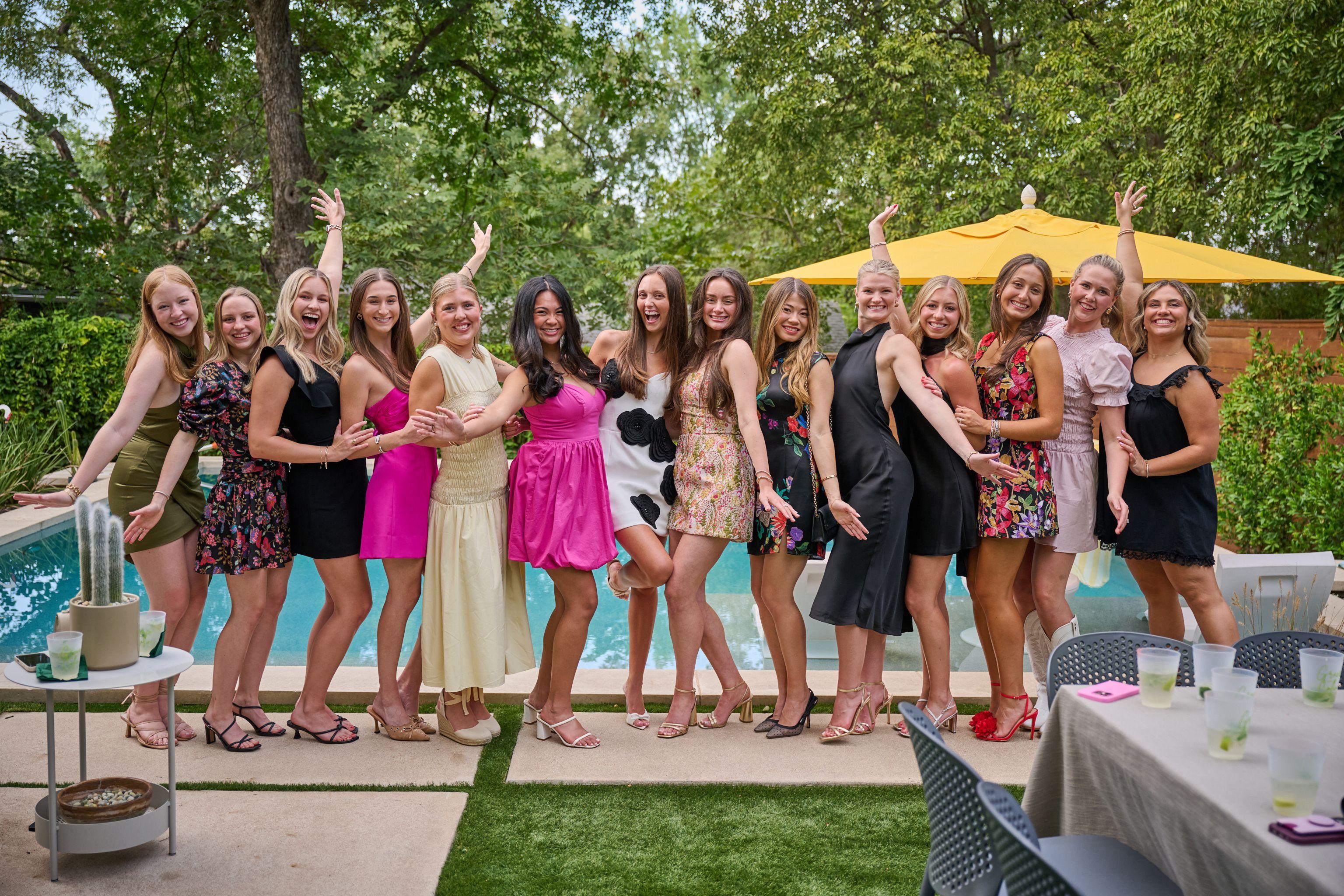 Line of young women in party dresses cheering along the edge of a swimming pool — Bachelor & Bachelorette photography, Austin A line of young women in party dresses cheering along the edge of a swimming pool.