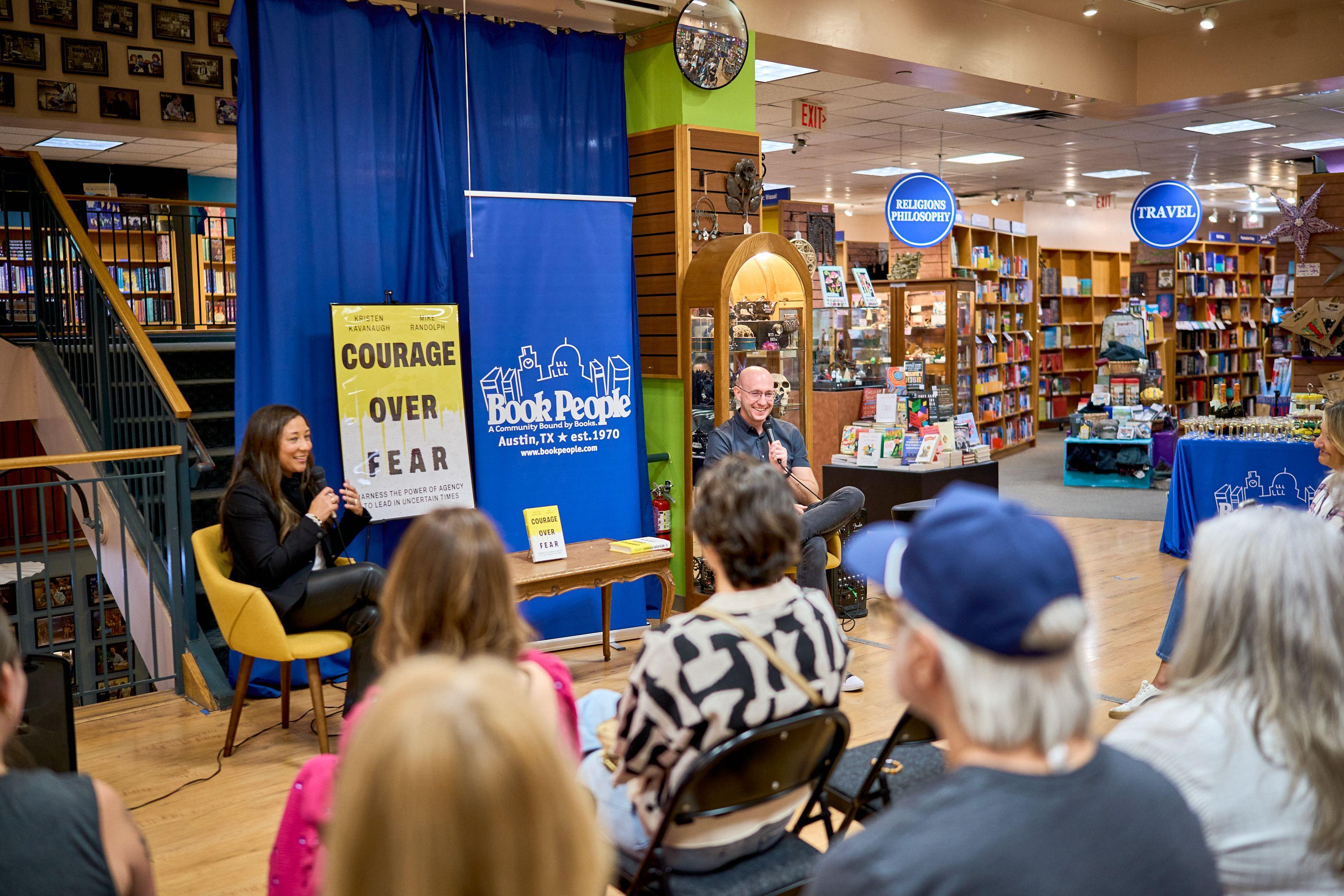 Author signing event inside a BookPeople store with a Courage Over Fear banner — Brand activation photography, Austin An author signing event inside a BookPeople store with a Courage Over Fear banner.